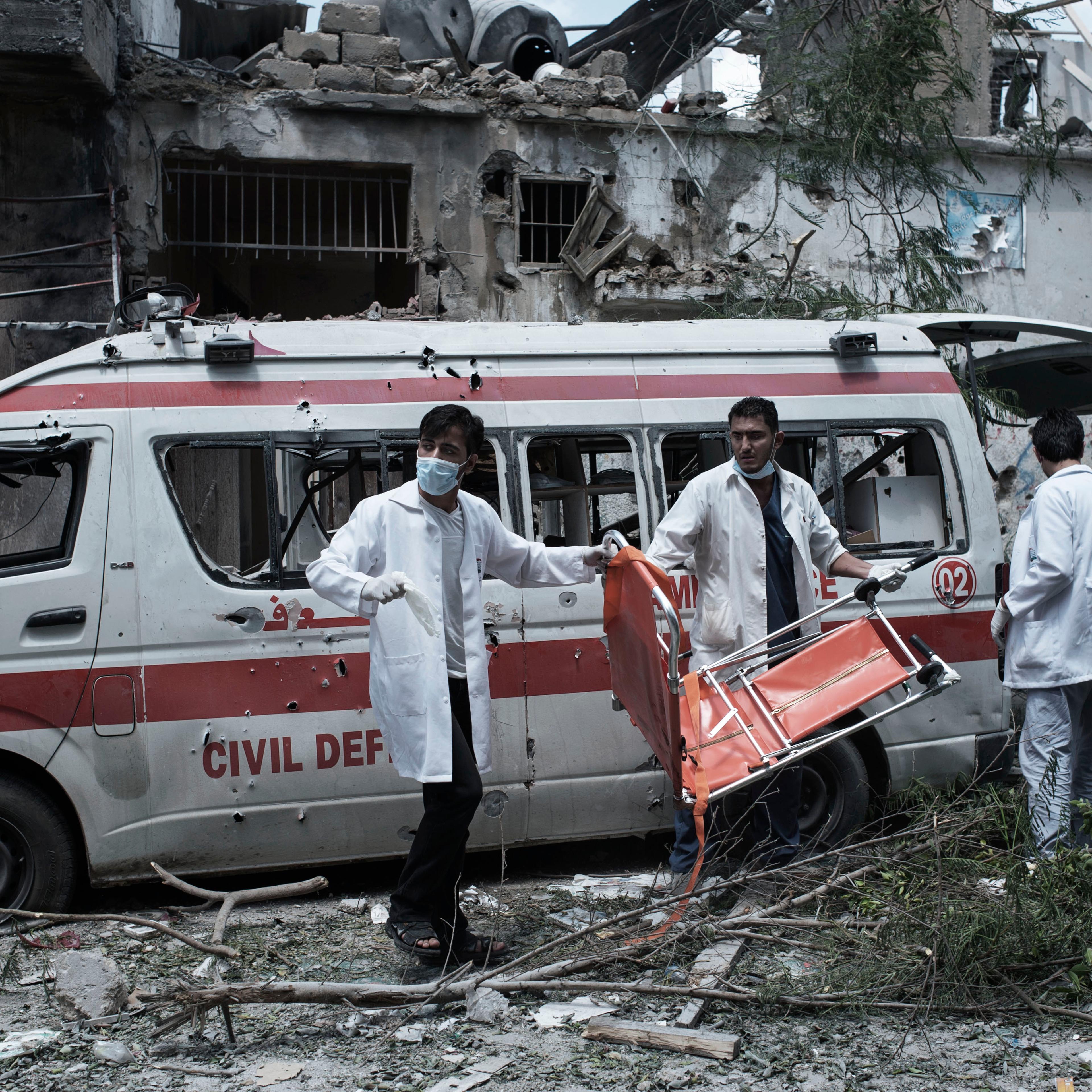 Gaza Strip, Gaza City: During a cease fire, Palestinians medics look for survivors in Gaza's Shujaya district after a night of Israeli heavy shelling on the neighbourhood. In the are two ambulances has been targeted few hours earlier. ALESSIO ROMENZI