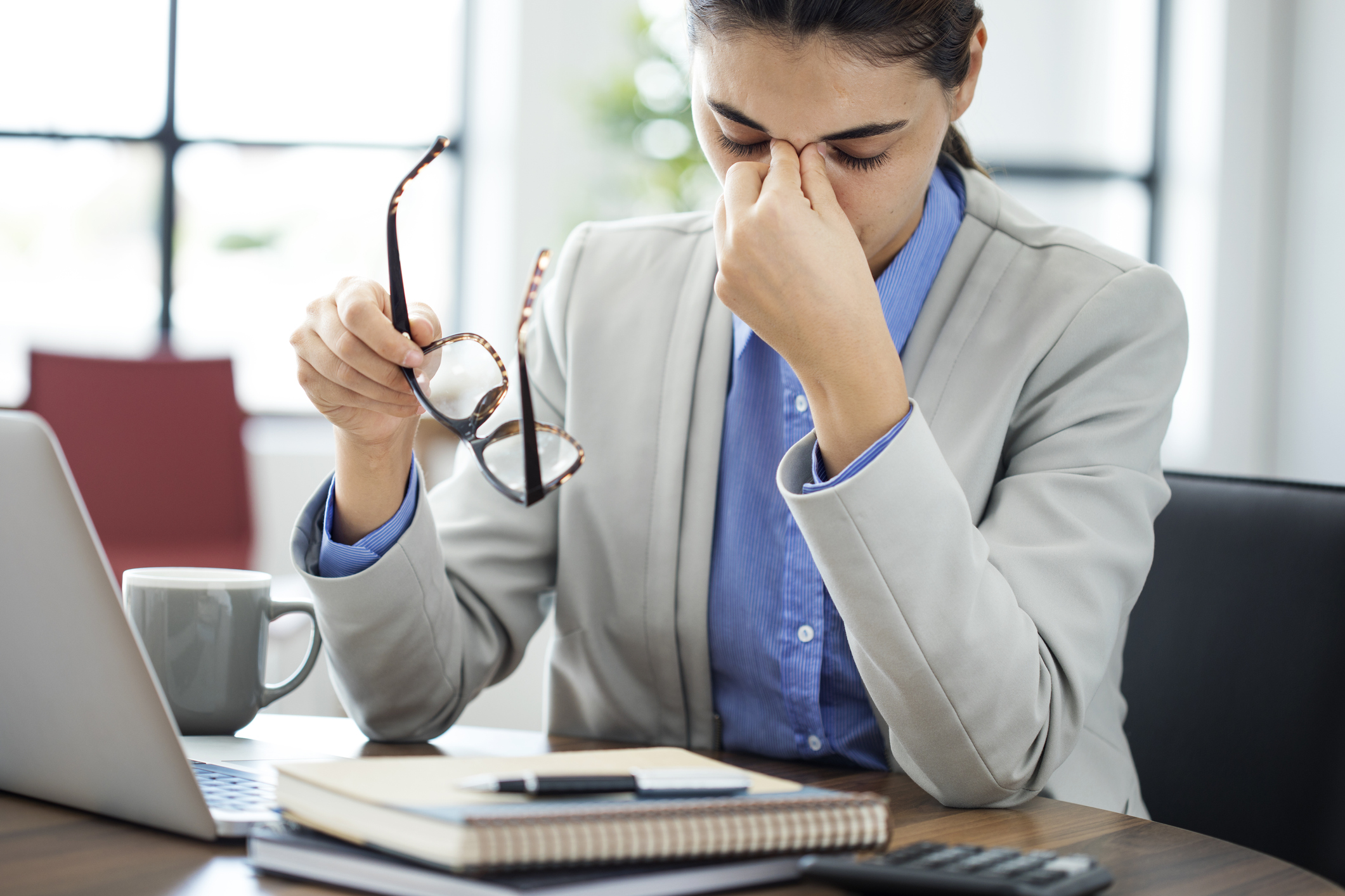 Businesswoman rubbing her tired eyes