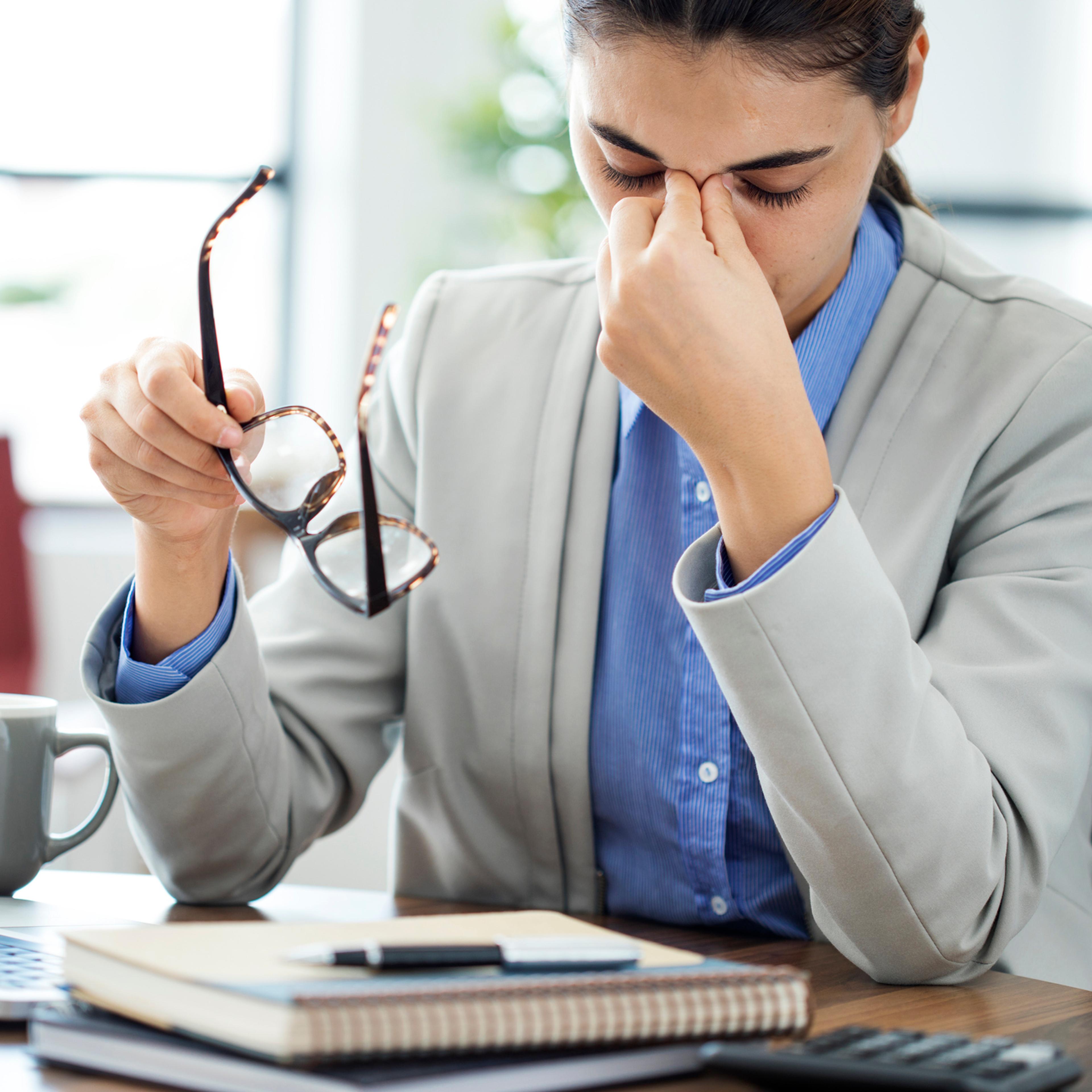 Businesswoman rubbing her tired eyes