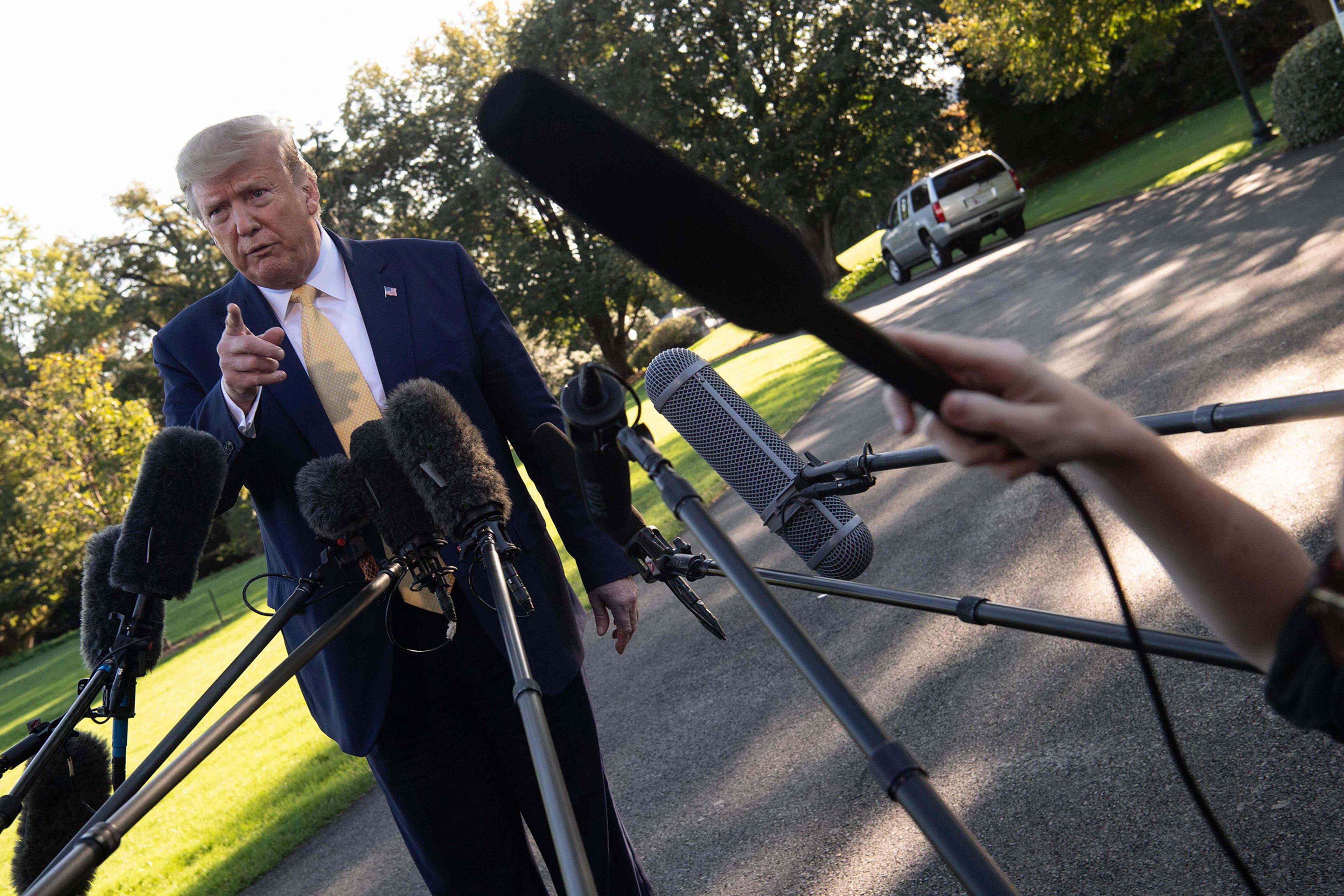 President Donald Trump speaks to the press from the South Lawn of the White House