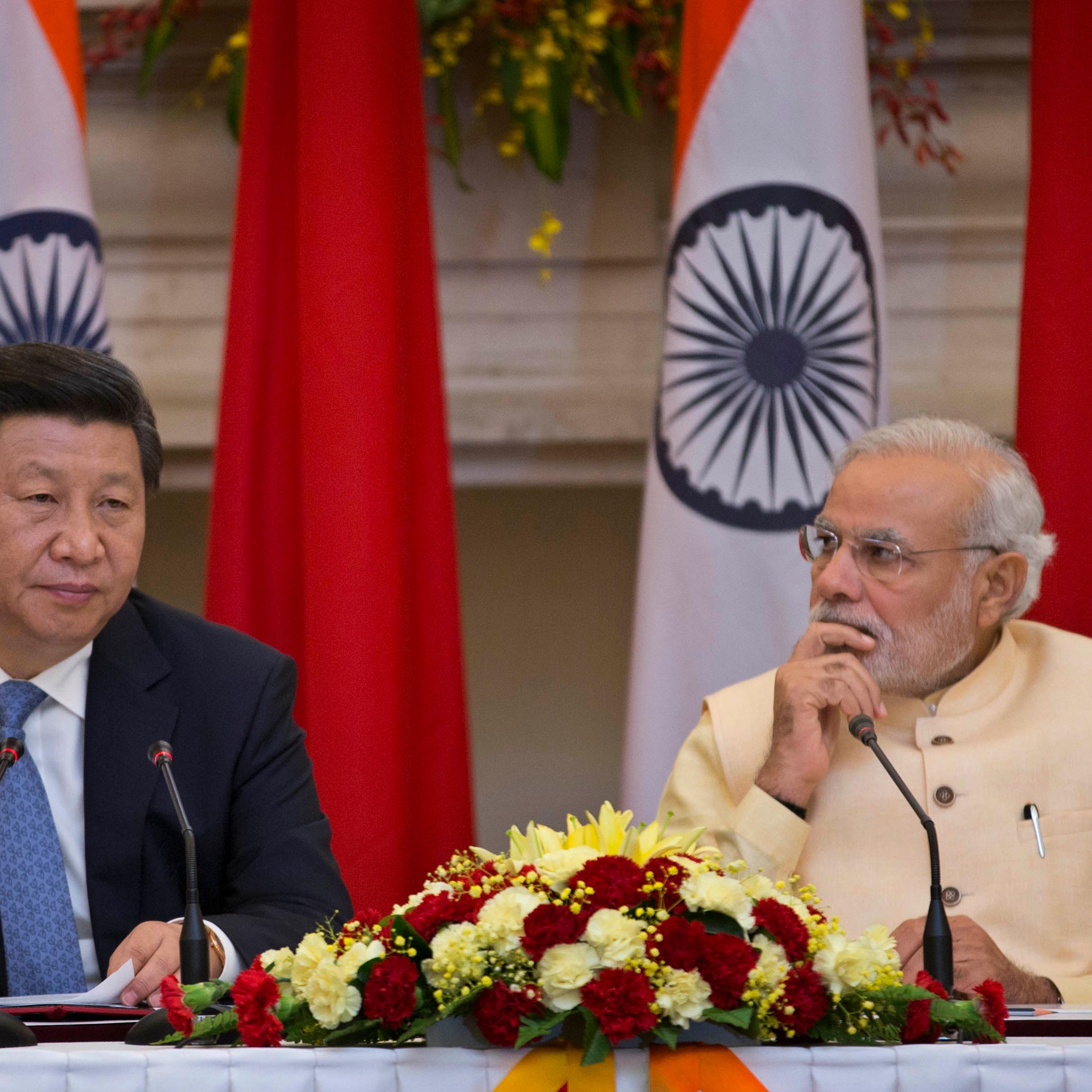 Chinese President Xi Jinping (L) makes a statement before the media as Indian Prime Minister Narendra Modi (R) watches after signing agreements in New Delhi, India on Sept. 18, 2014.