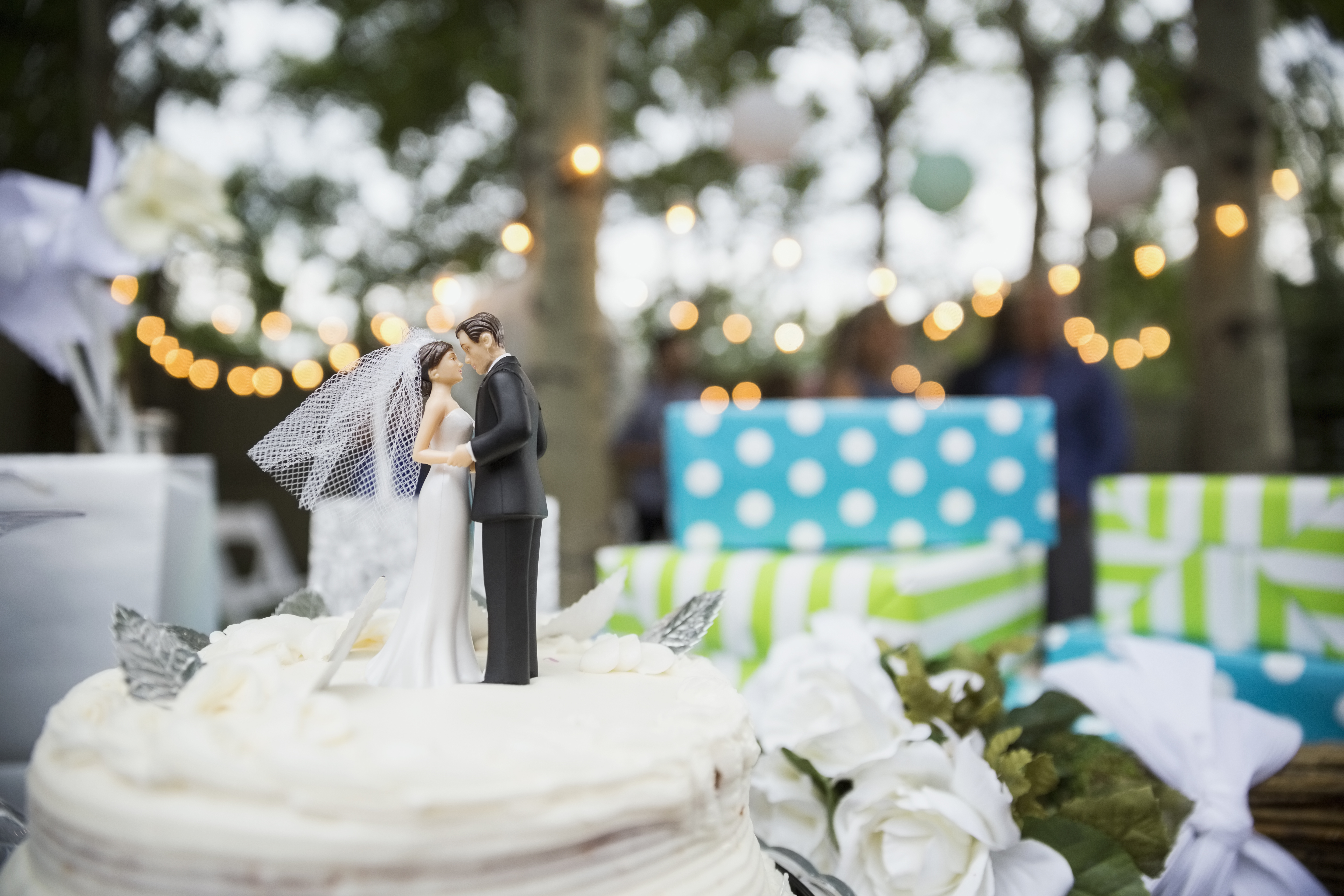 Bride and groom cake topper on cake