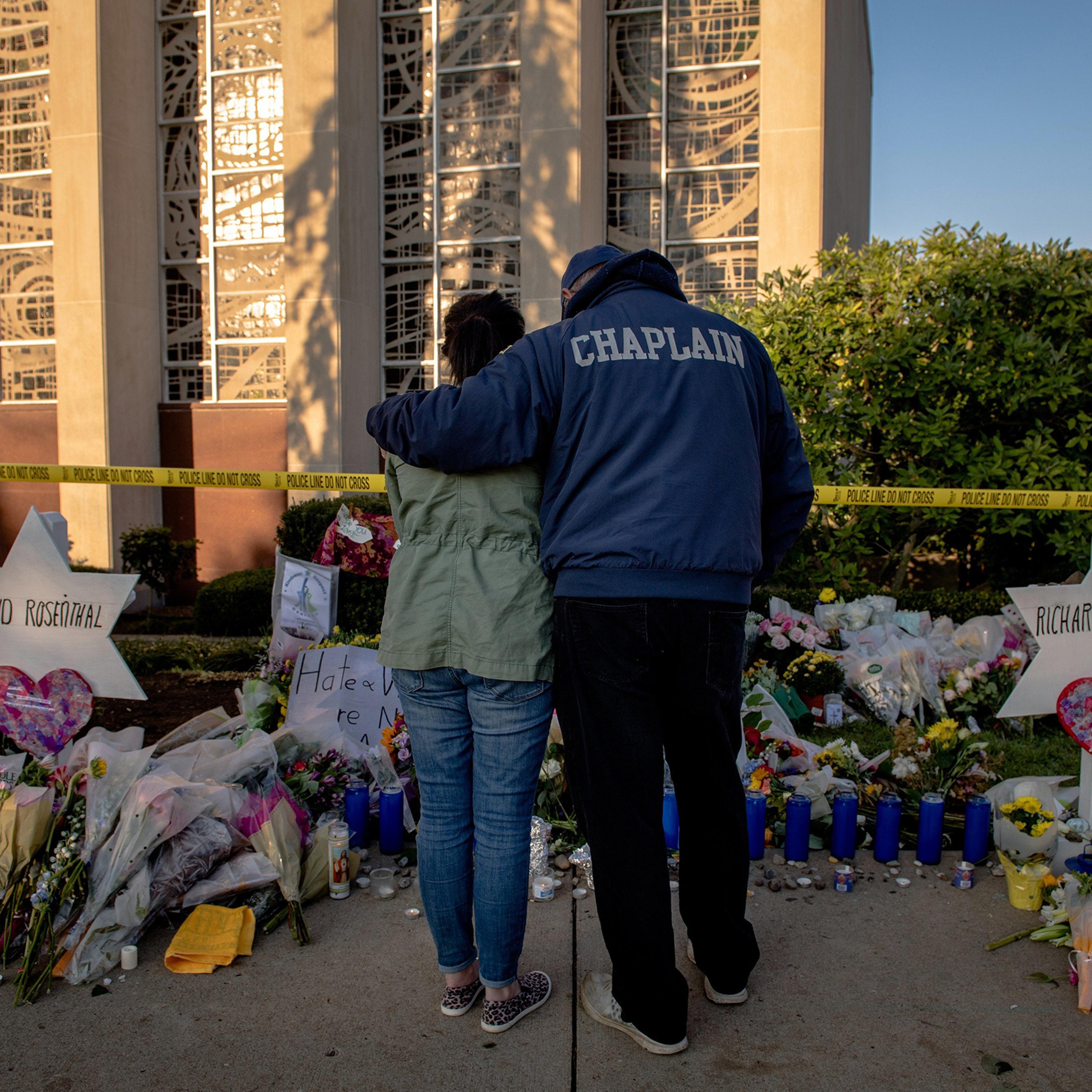 Bob Ossler, a fire department chaplain from Cape Coral, Fla., comforts Melissa Kirchner outside the Tree of Life synagogue on Oct. 30