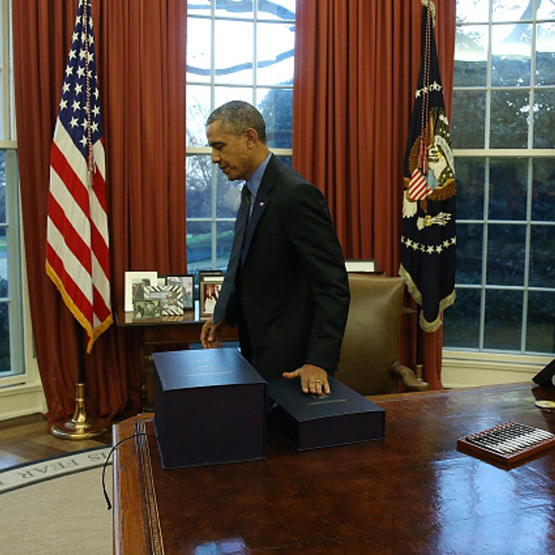 US President Barack Obama gets up from his desk after signing the budget bill that will fund the government until next September, in the Oval Office at the White House December 18, 2015 in Washington, DC.