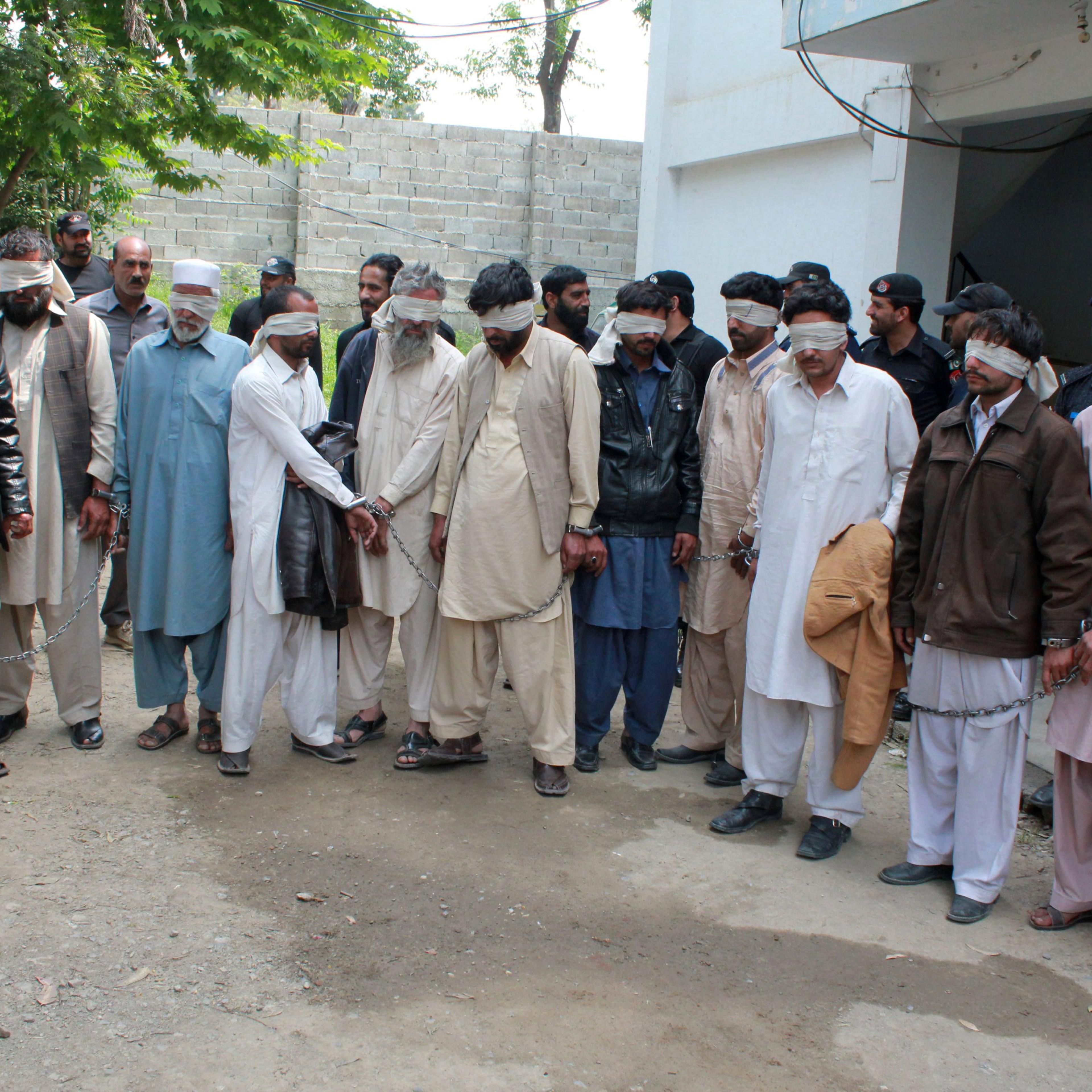 Members of a tribal council accused of ordering the burning death of a 16 year old girl are shown to the media after they were arrested by police in Donga Gali, outside Abbottabad