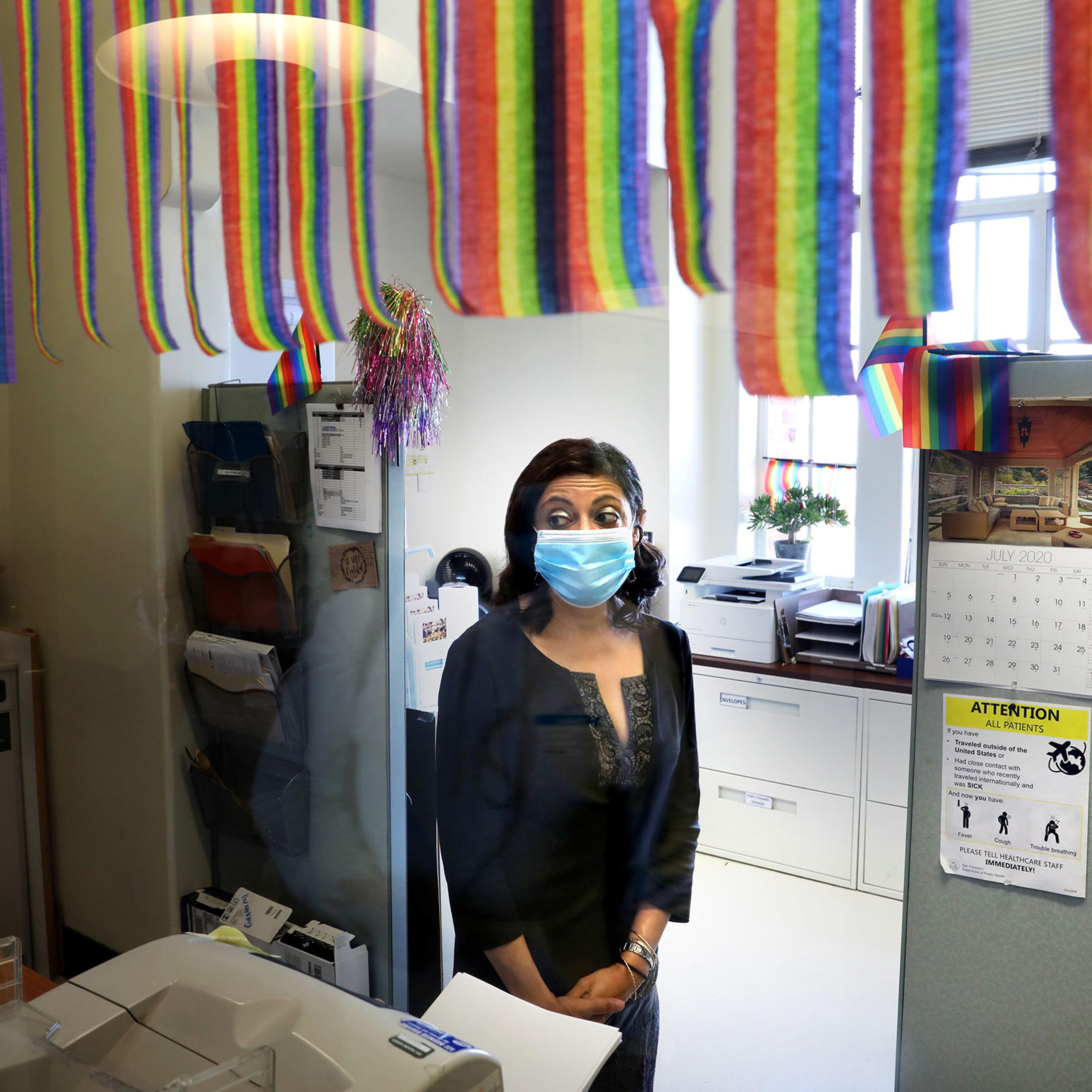 Medical director of Ward 86 at San Francisco General, Monica Gandhi, watches as patients get off the elevator on July 2, 2020.