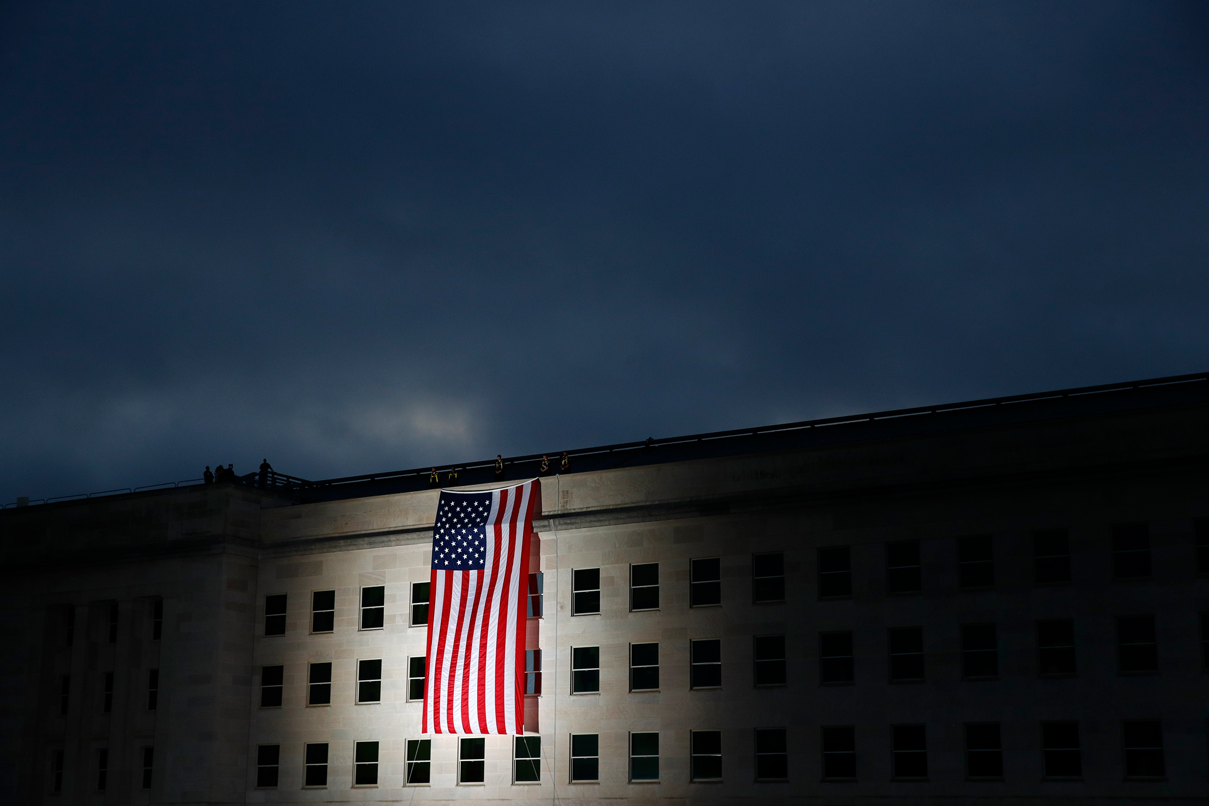 An American flag is unfurled at sunrise at the Pentagon in Washington, D.C., on Sept. 11, 2019, the 18th anniversary of the attacks.