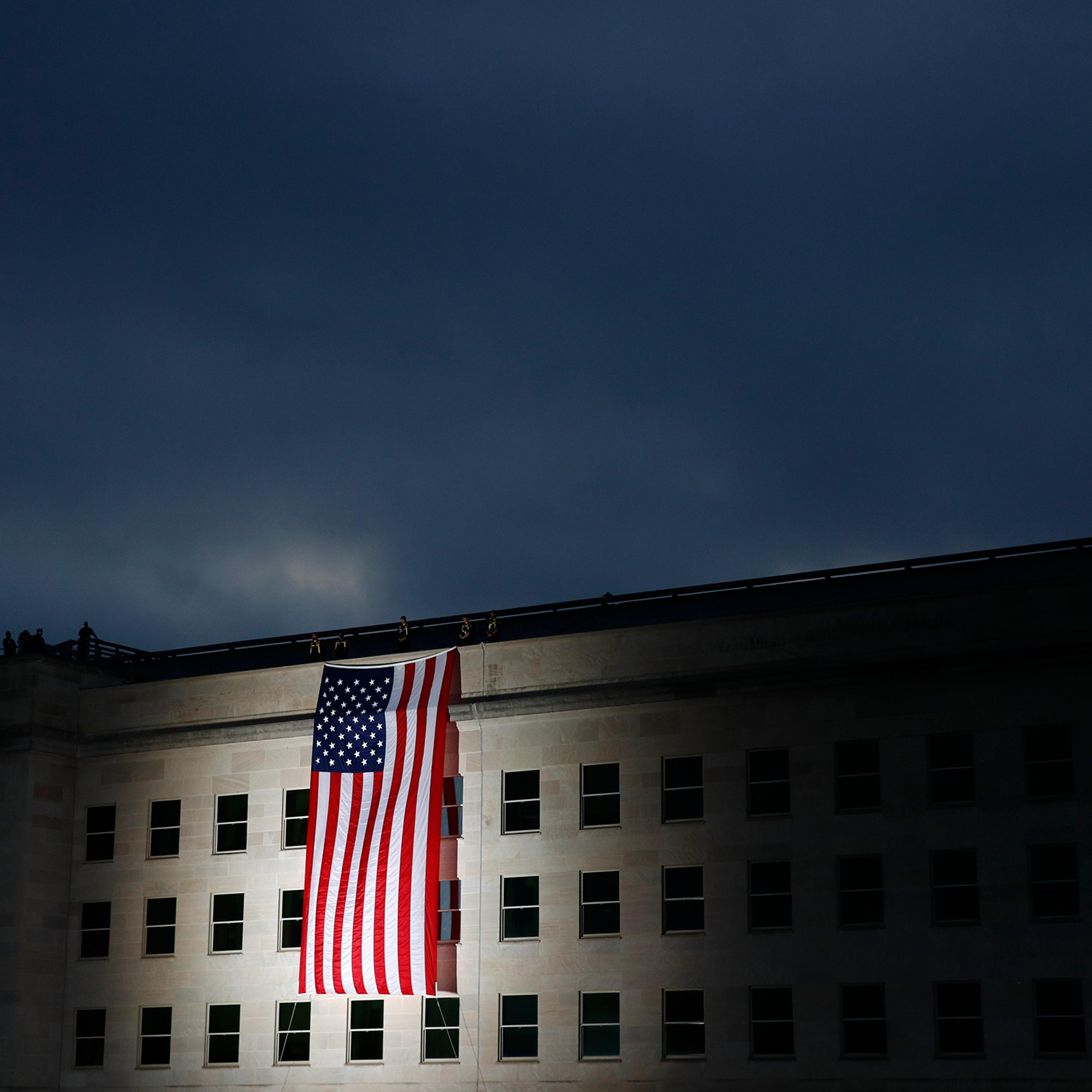 An American flag is unfurled at sunrise at the Pentagon in Washington, D.C., on Sept. 11, 2019, the 18th anniversary of the attacks.
