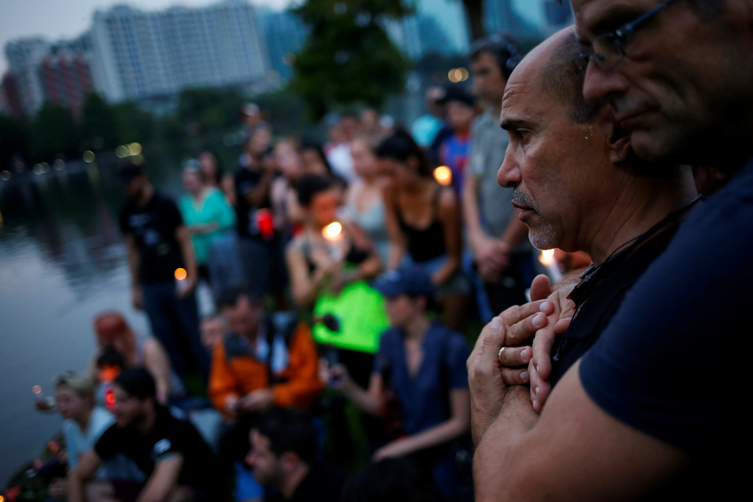 Wilfredo Perez (L), a local bartender at a gay bar, is embraced by his partner Jackson Hollman during a vigil to commemorate victims of a mass shooting at the Pulse gay night club in Orlando, June 12, 2016.