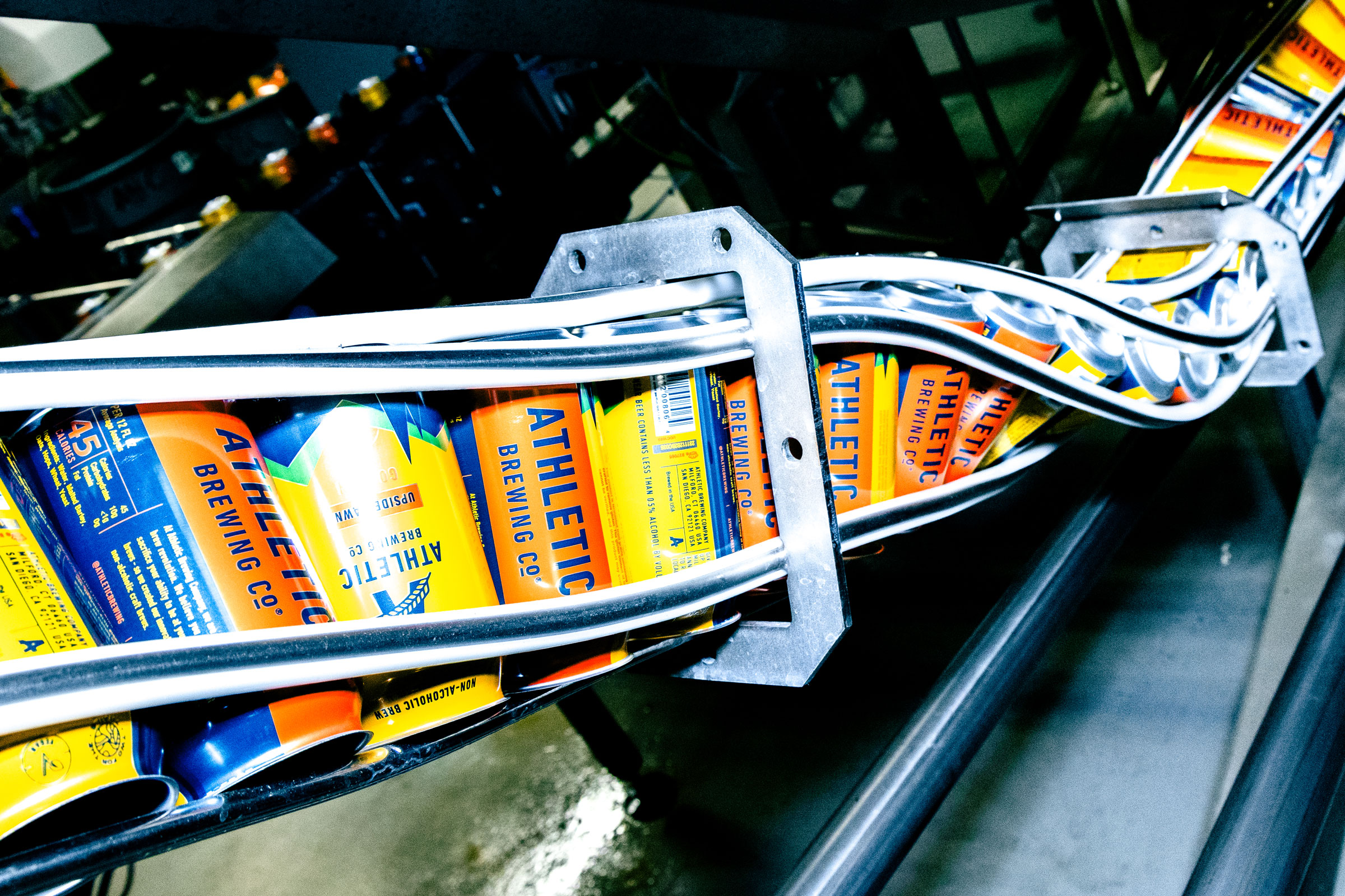 cans of Athletic Brewing Co. beer at a processing plant