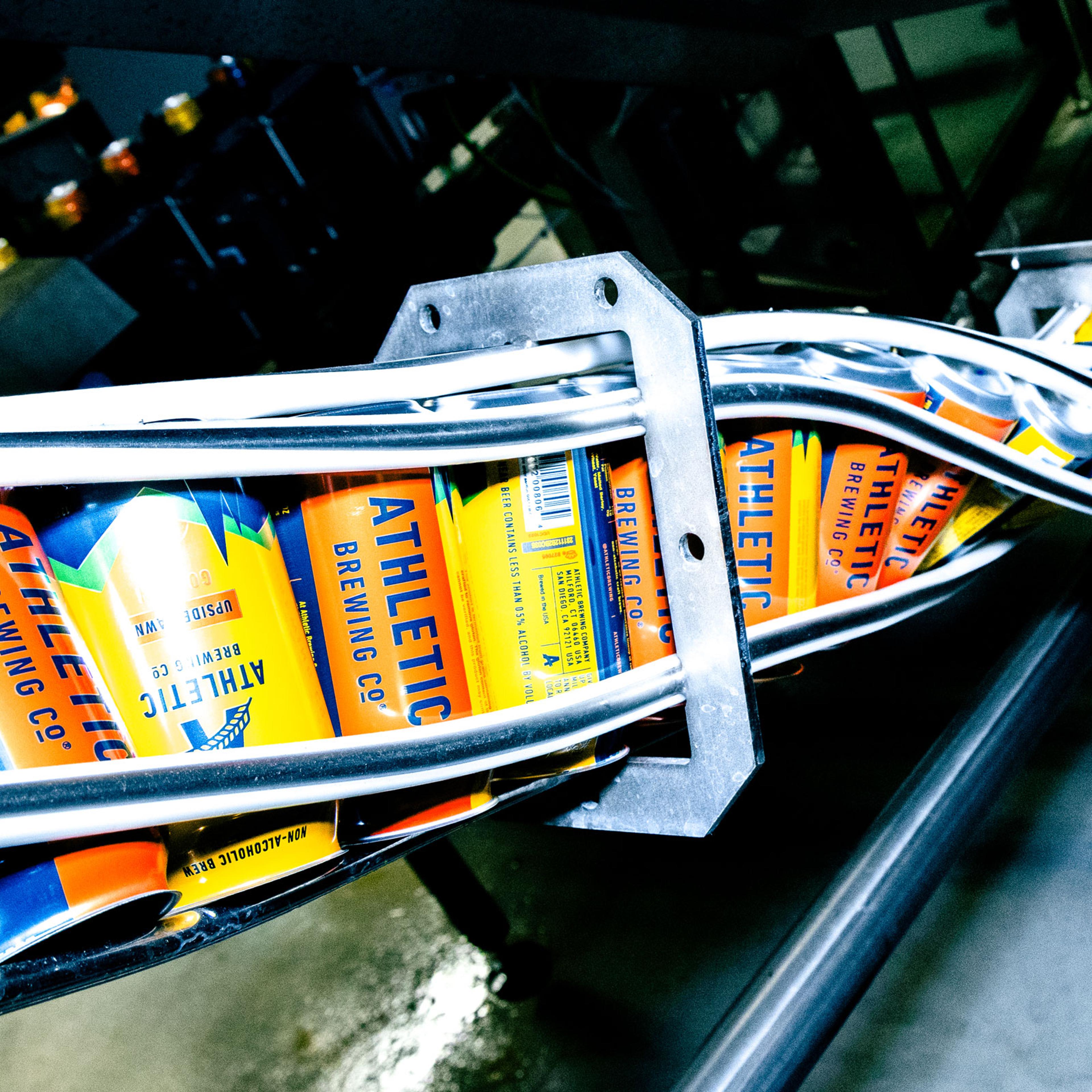 cans of Athletic Brewing Co. beer at a processing plant