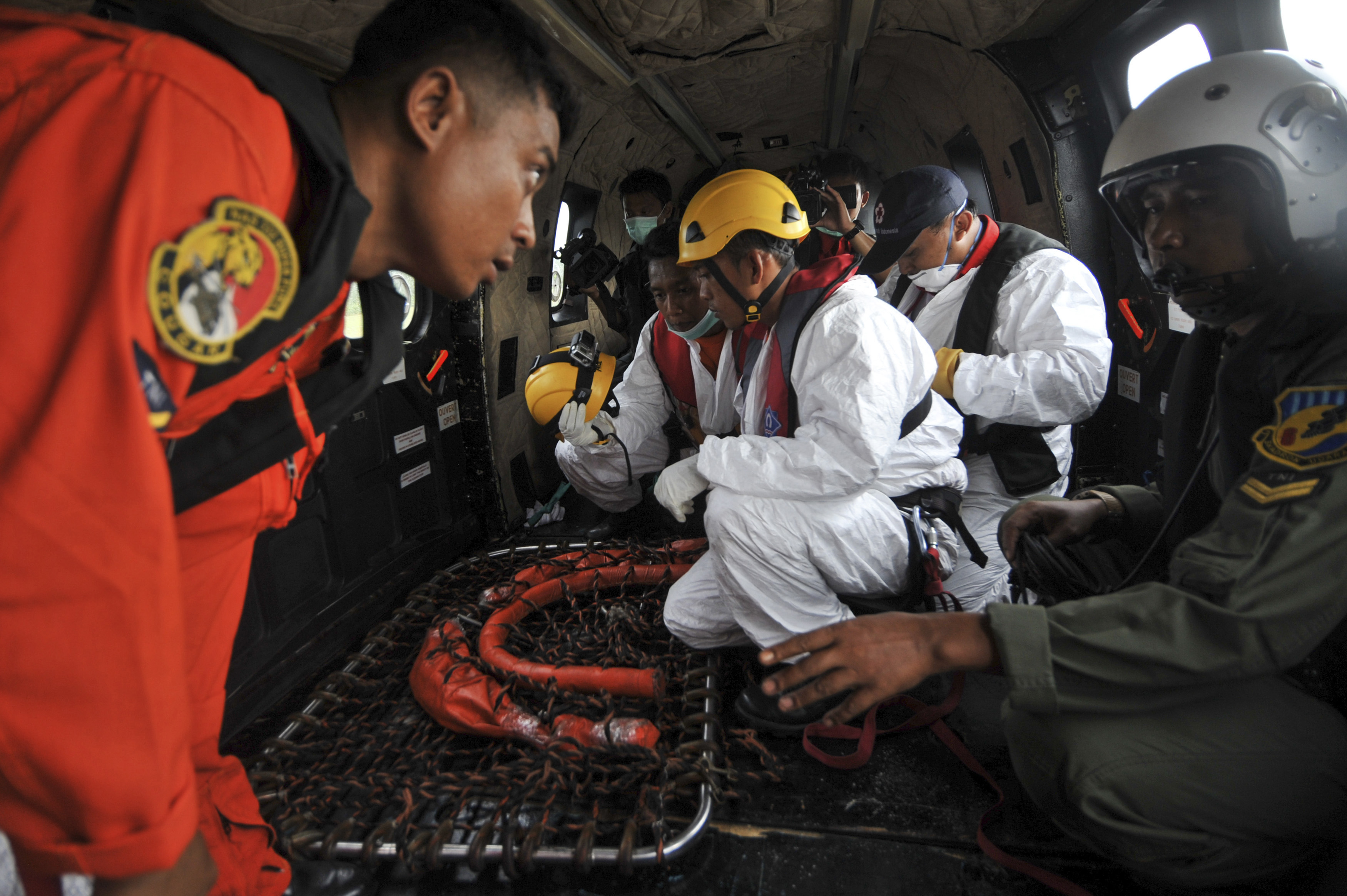 Search and rescue teams and flight crew prepare their gear on board an Indonesian Air Force Super Puma helicopter before a search mission for debris and bodies from AirAsia flight QZ8501at Iskandar Air Force Base, in Pangkalan Bun