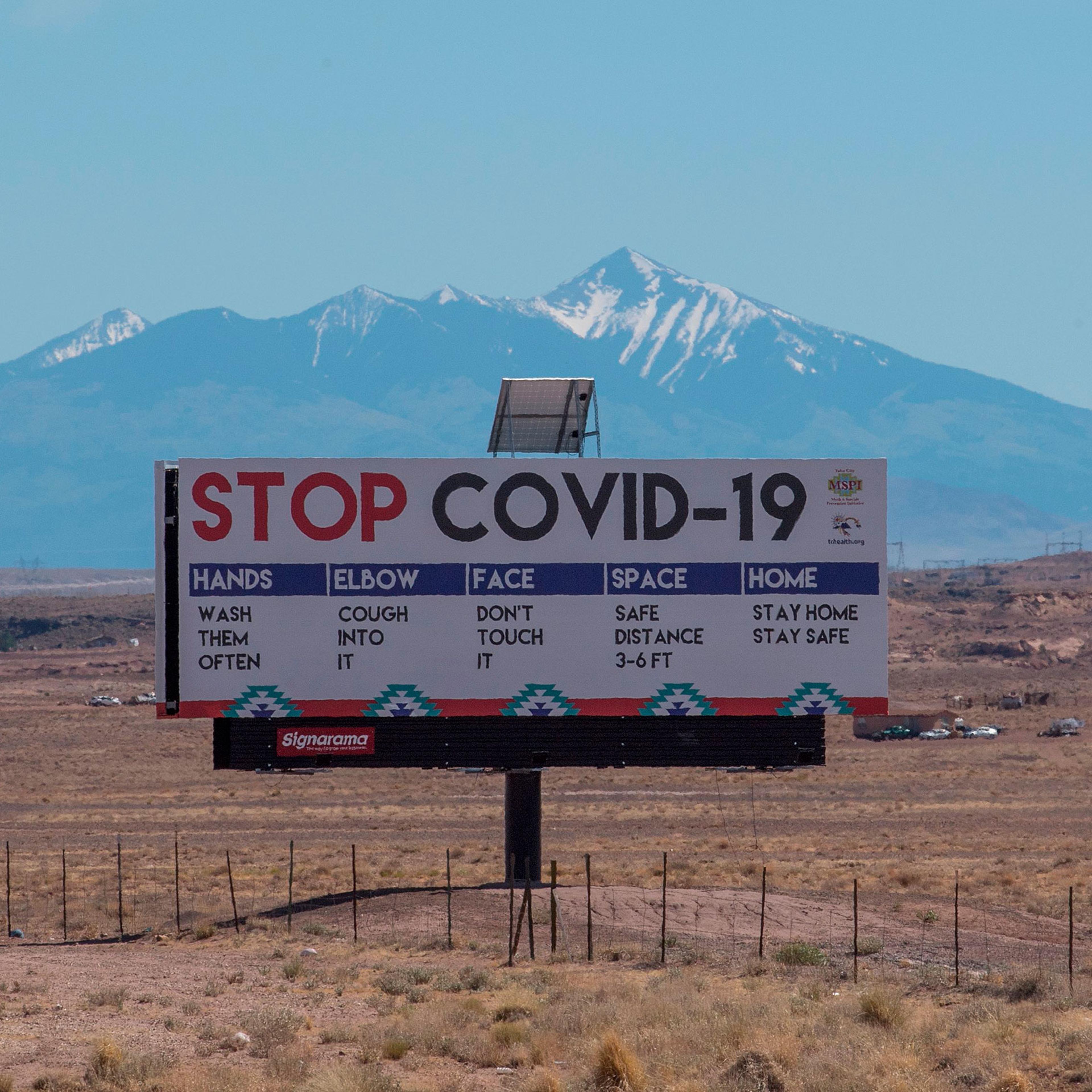 A sign warns against the Covid-19 virus near the Navajo Indian nation town of Tuba City, Arizona on May 24, 2020.