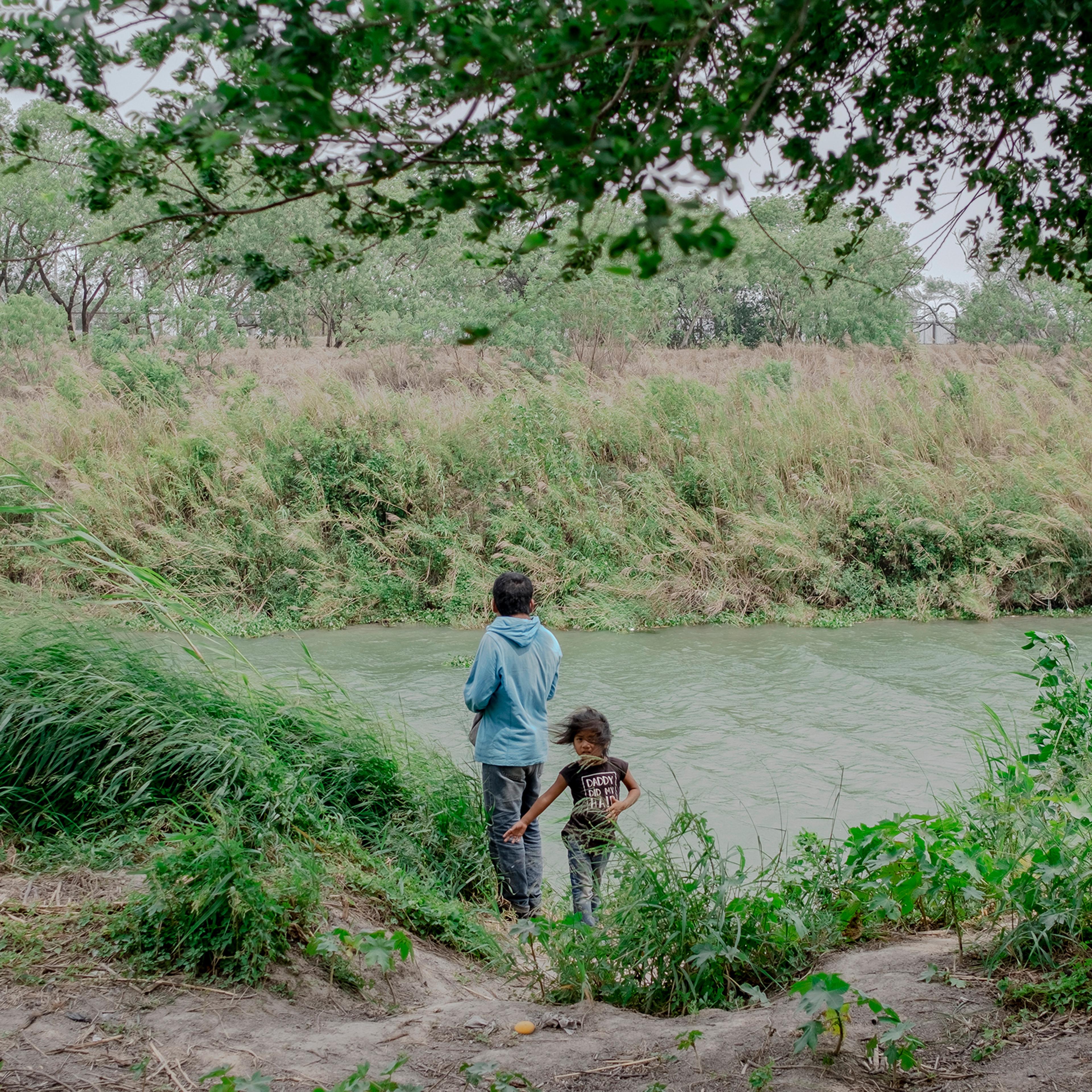 Asylum seekers on the bank of the Rio Grande in Matamoros, Mexico, on April 22. In the city just over the U.S. border from Brownsville, Texas, roughly 2,500 asylum seekers await their court dates living on a muddy strip of land the size of two football f