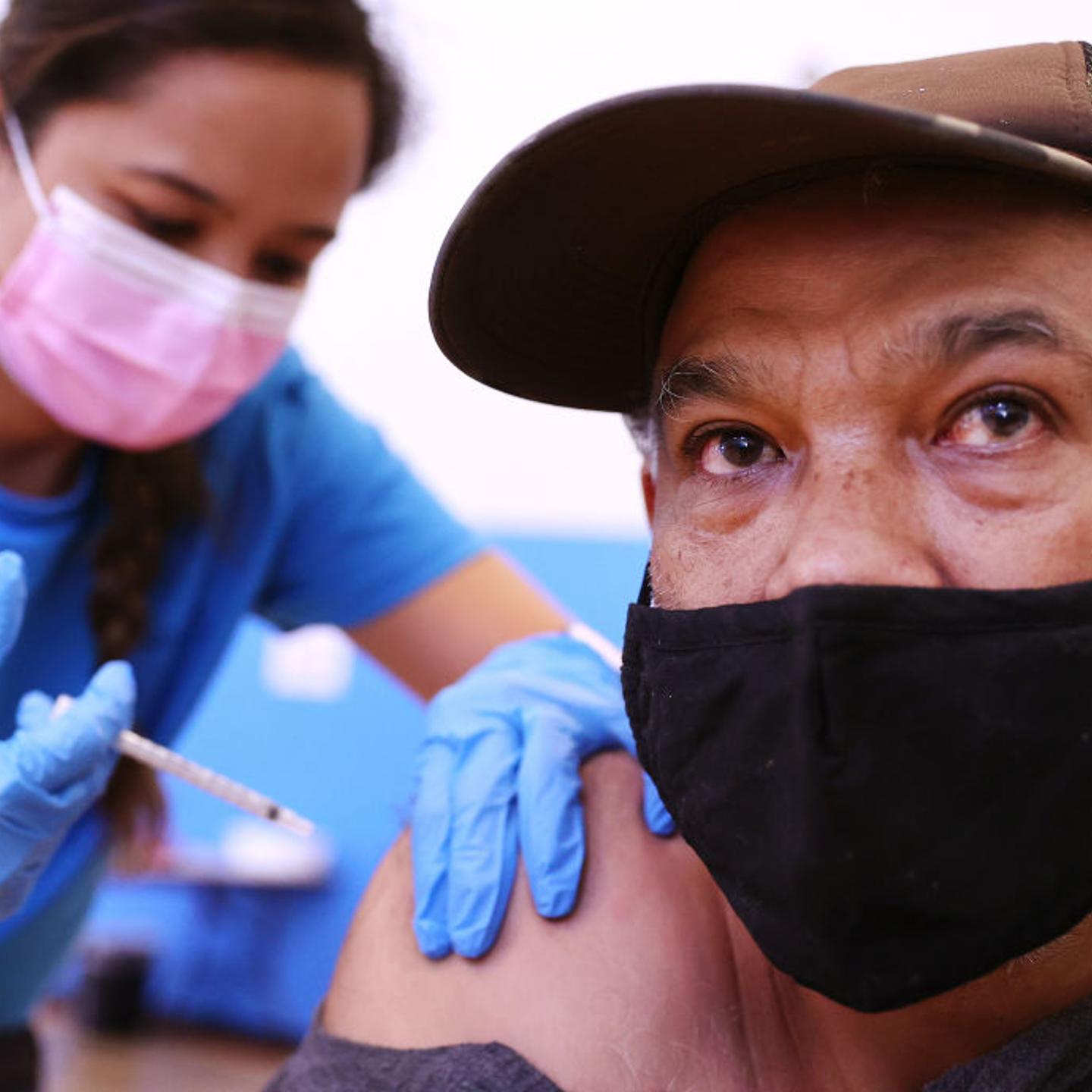 Registered nurse Darryl Hana administers a dose of the Pfizer COVID-19 vaccine to a person at a three-day vaccination clinic at Providence Wilmington Wellness and Activity Center on July 29, 2021 in Wilmington, California.