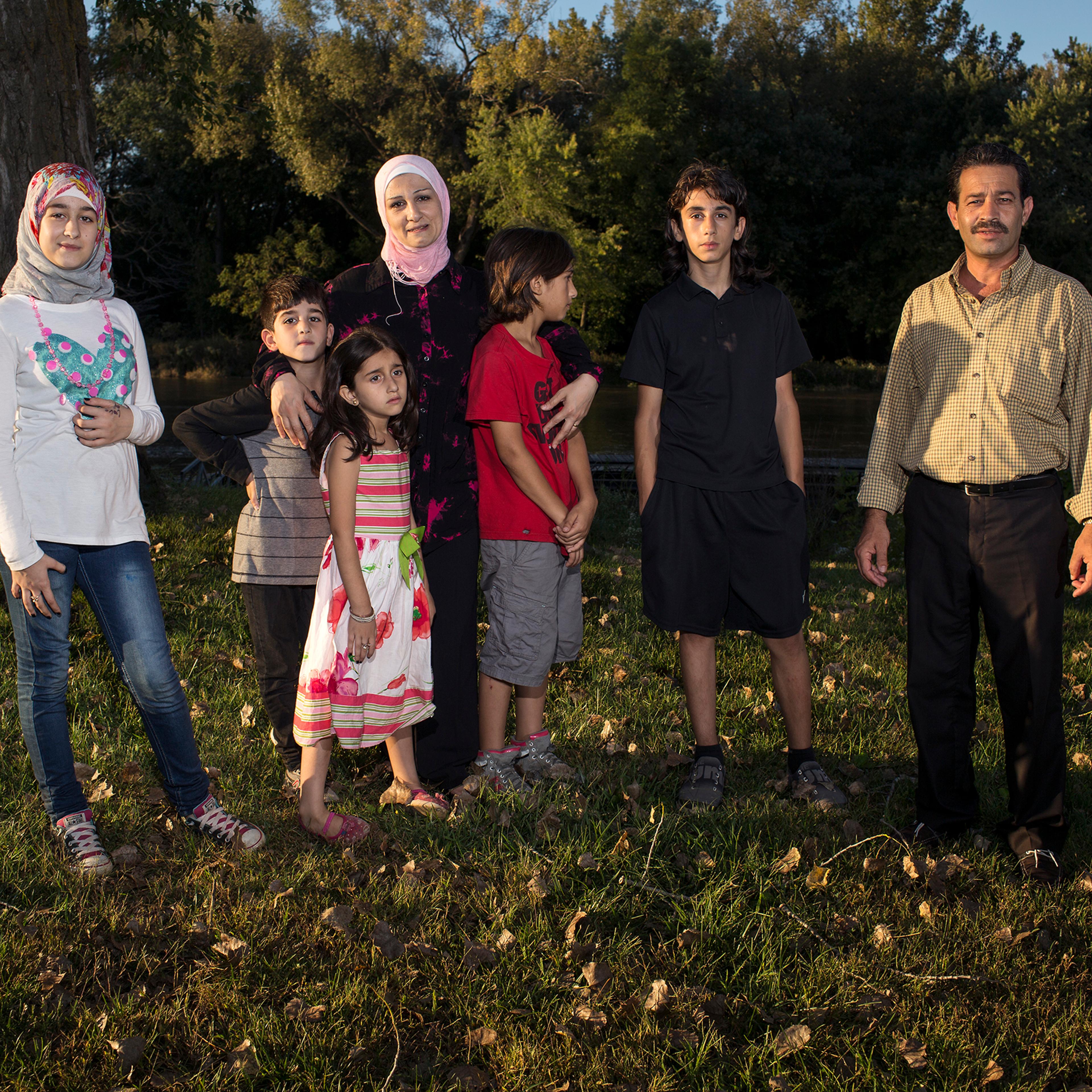 Ghazweh and Abdul Fattah at a park in Des Moines in 2016 with their children, from left to right: Sedra, Mutaz, Hala, Haidar and Nazeer. That year, the Tameems became the first Syrian refugee family to be resettled in Iowa. In the four decades of the U.S