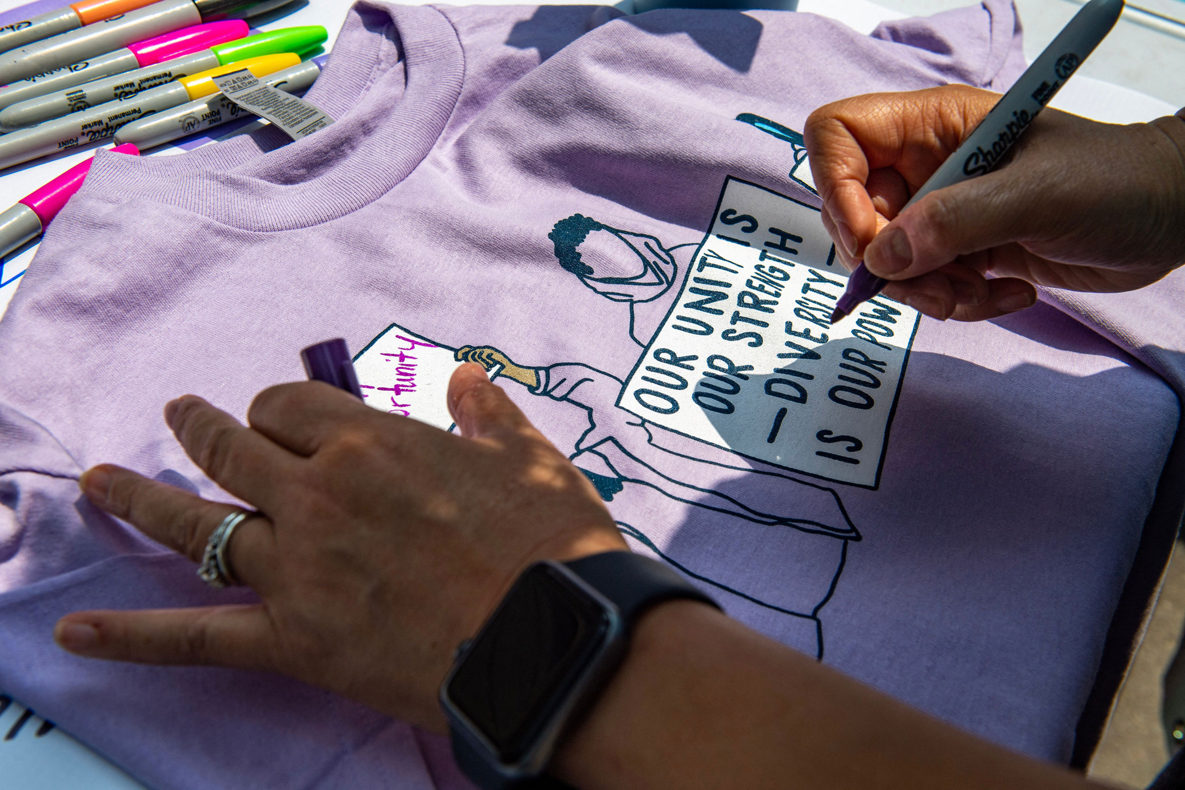 A proponent of affirmative action signs a shirt during a protest at Harvard University