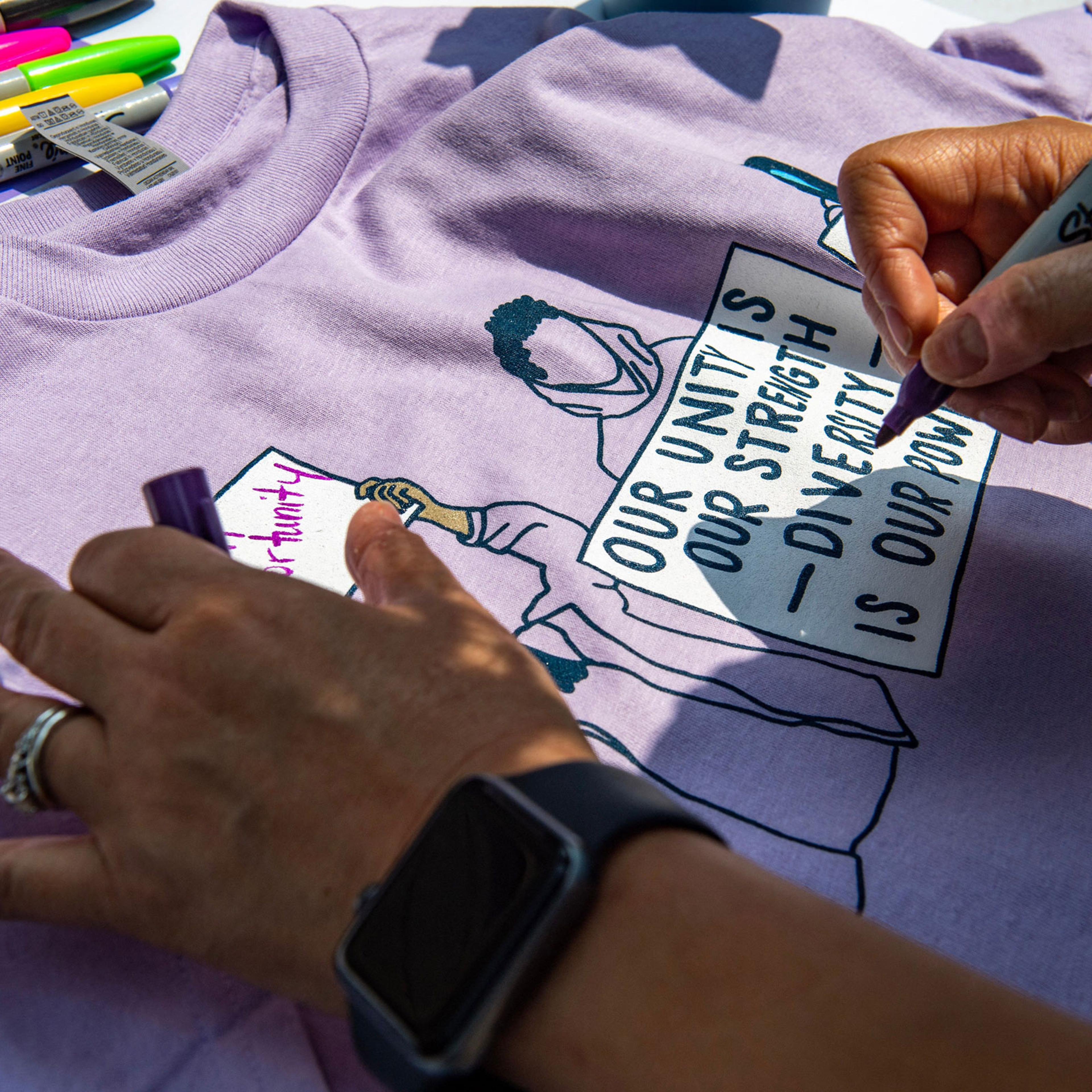 A proponent of affirmative action signs a shirt during a protest at Harvard University
