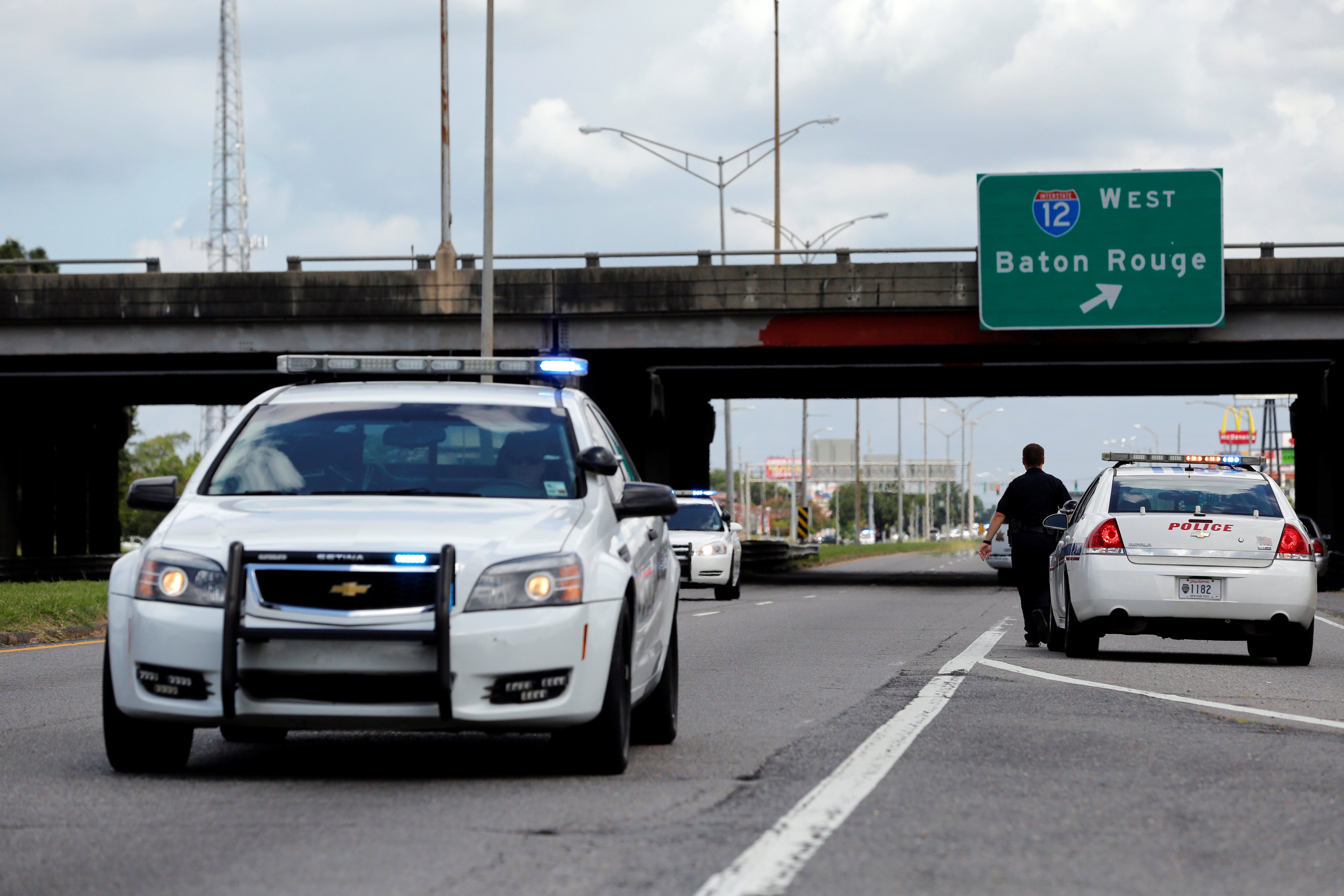 Police officers block off a road after a shooting of police in Baton Rouge, July 17, 2016.