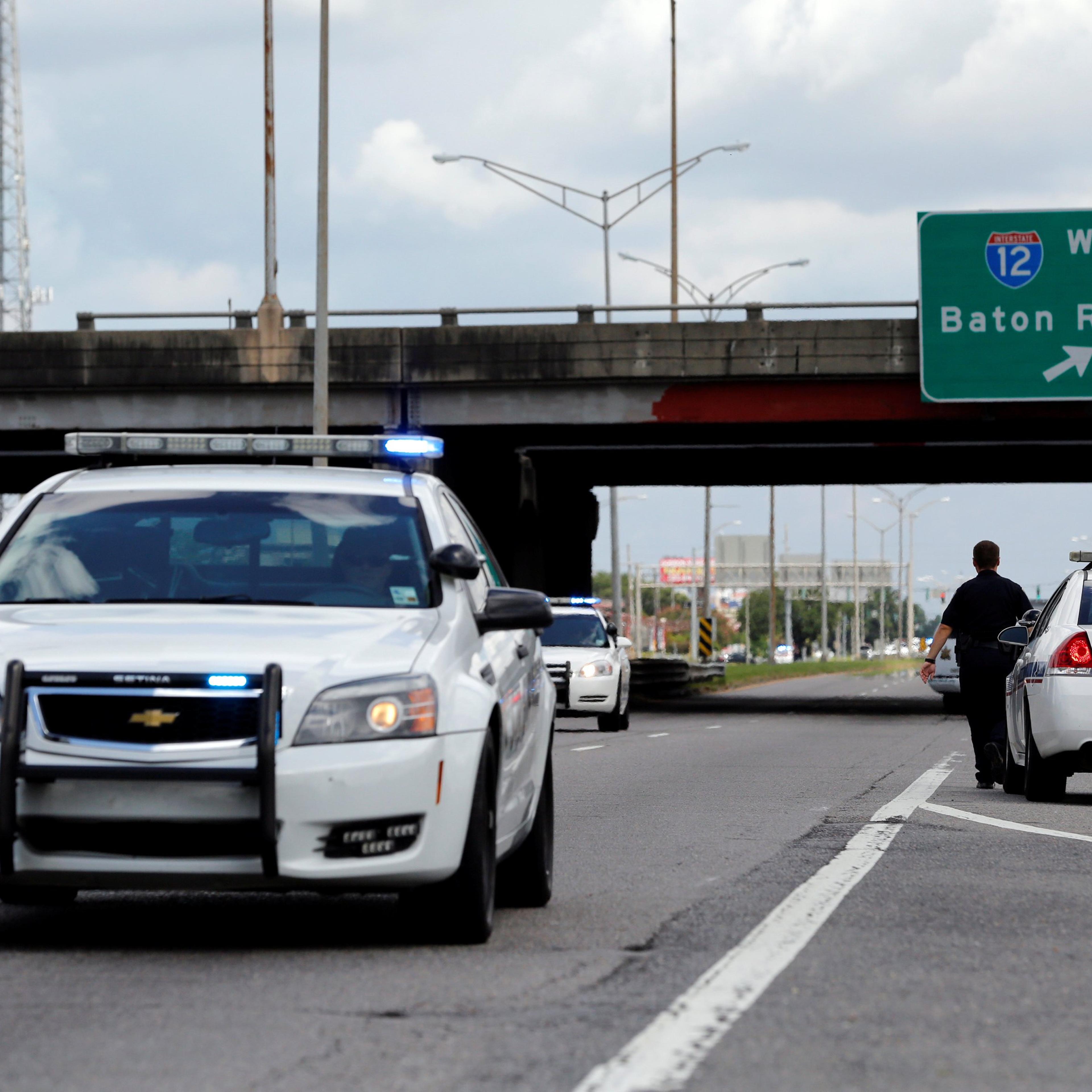 Police officers block off a road after a shooting of police in Baton Rouge, July 17, 2016.