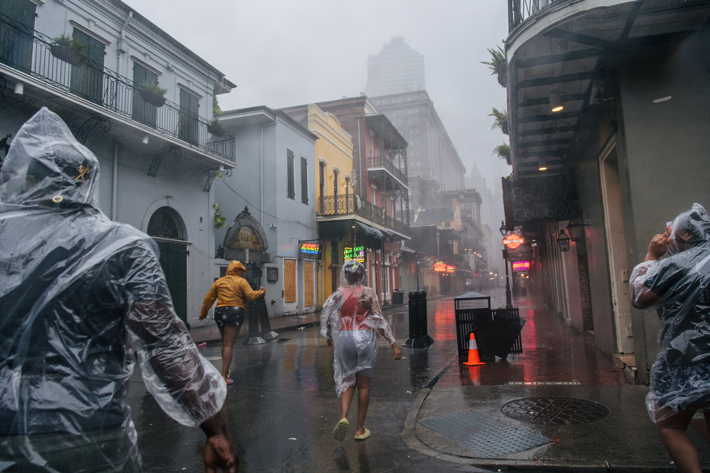 A group of people walk through the French District during Hurricane Ida in New Orleans on Aug. 29, 2021.