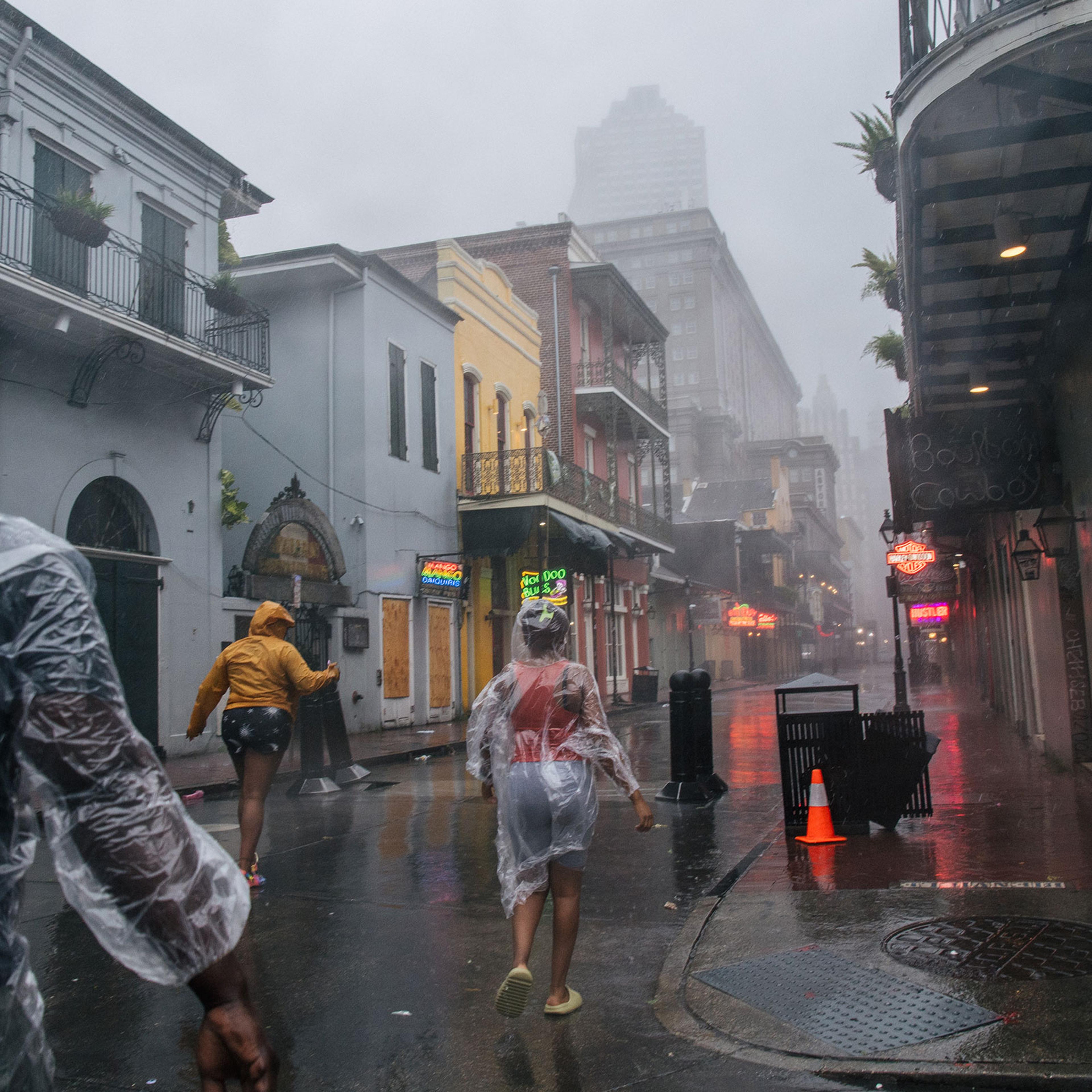A group of people walk through the French District during Hurricane Ida in New Orleans on Aug. 29, 2021.