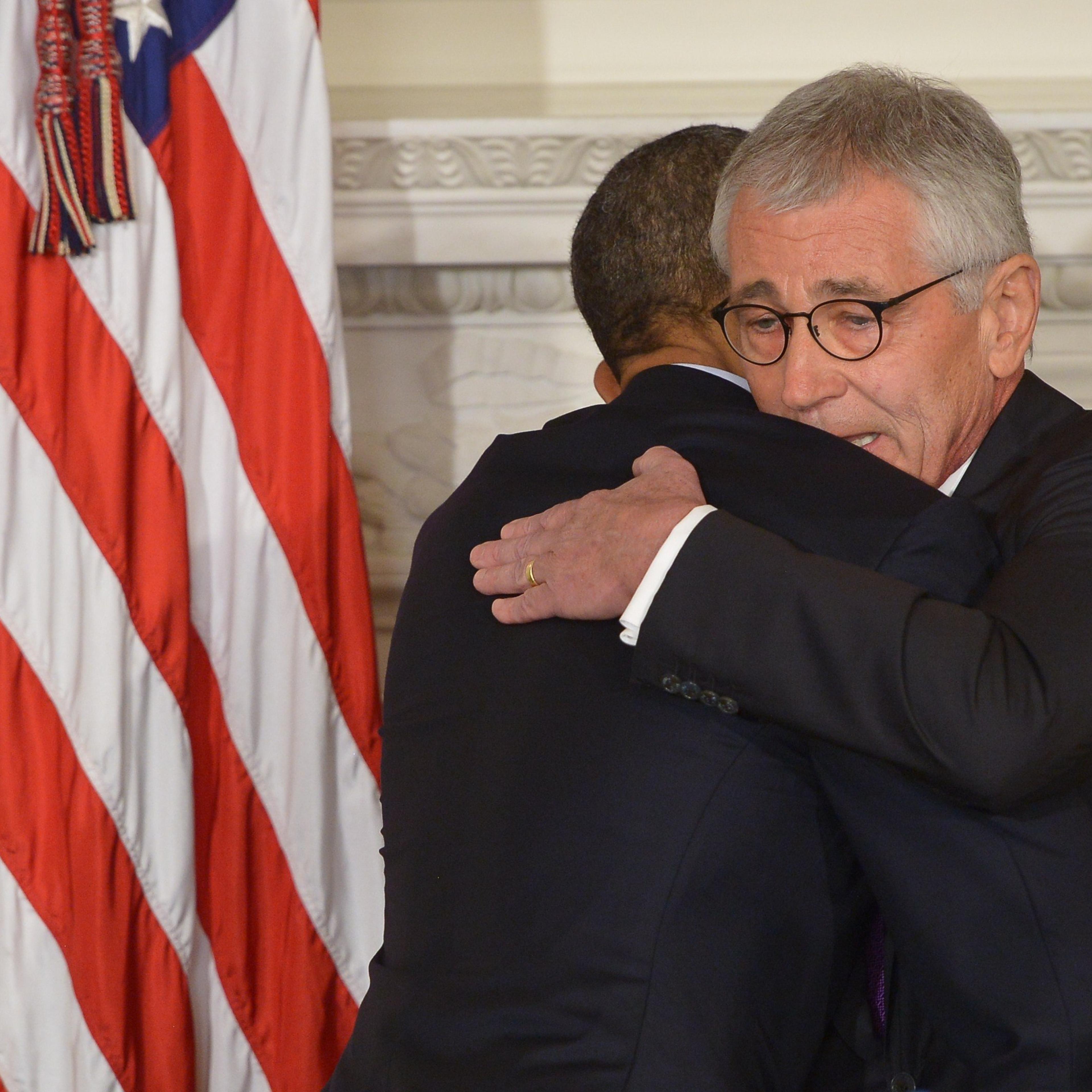 President Barack Obama and Defense Secretary Chuck Hagel embrace during a press conference to announce Hagel's departure at the White House on Nov. 24, 2014 in Washington, DC.