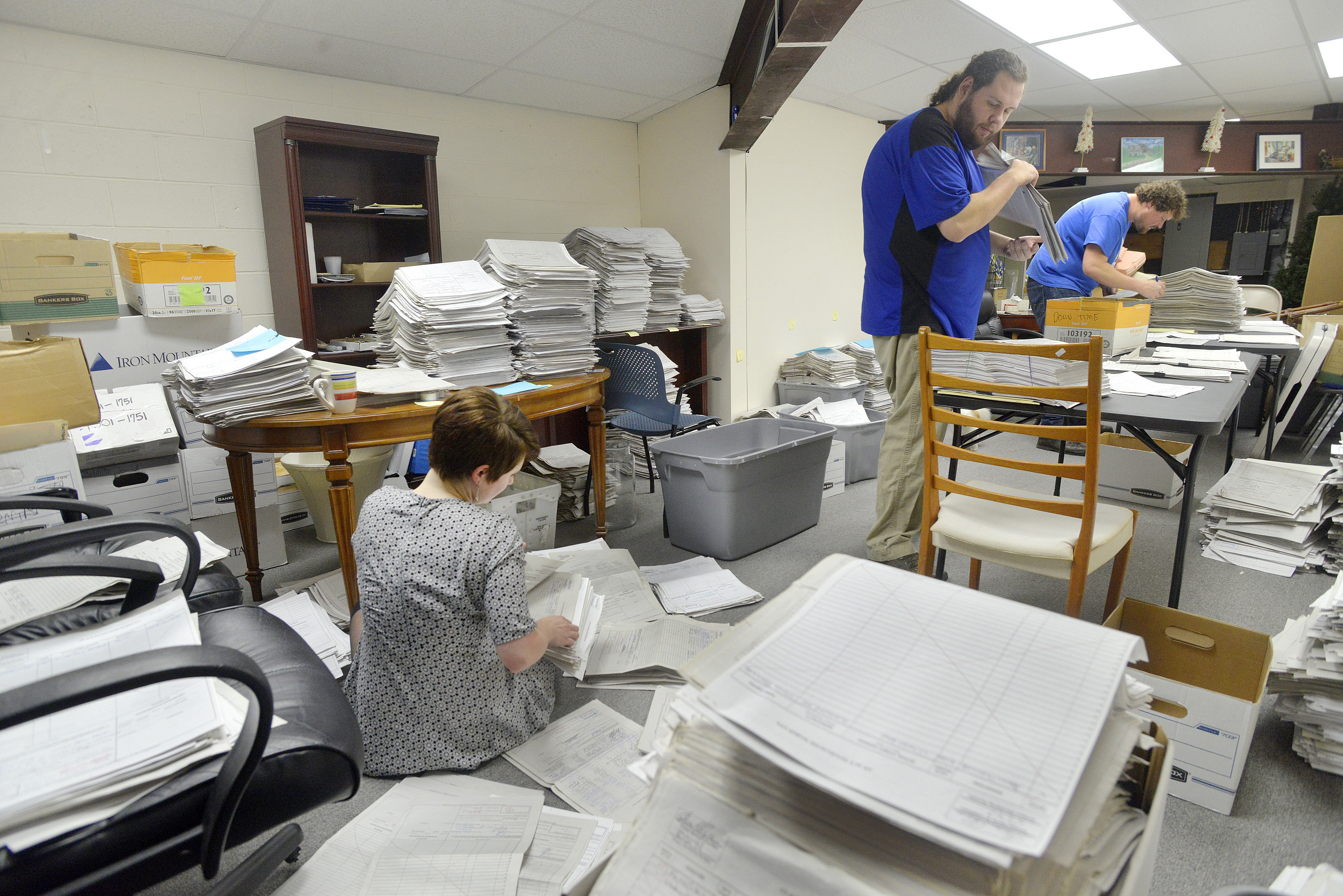 FALMOUTH, ME - JANUARY 26: Staff and volunteers  for the marijuana legalization campaign are sorting petitions at their office in Falmouth. Volunteer Allison Cormier (left) along with office manager Shaun Bowen (center) and field director Jordan DeCoster