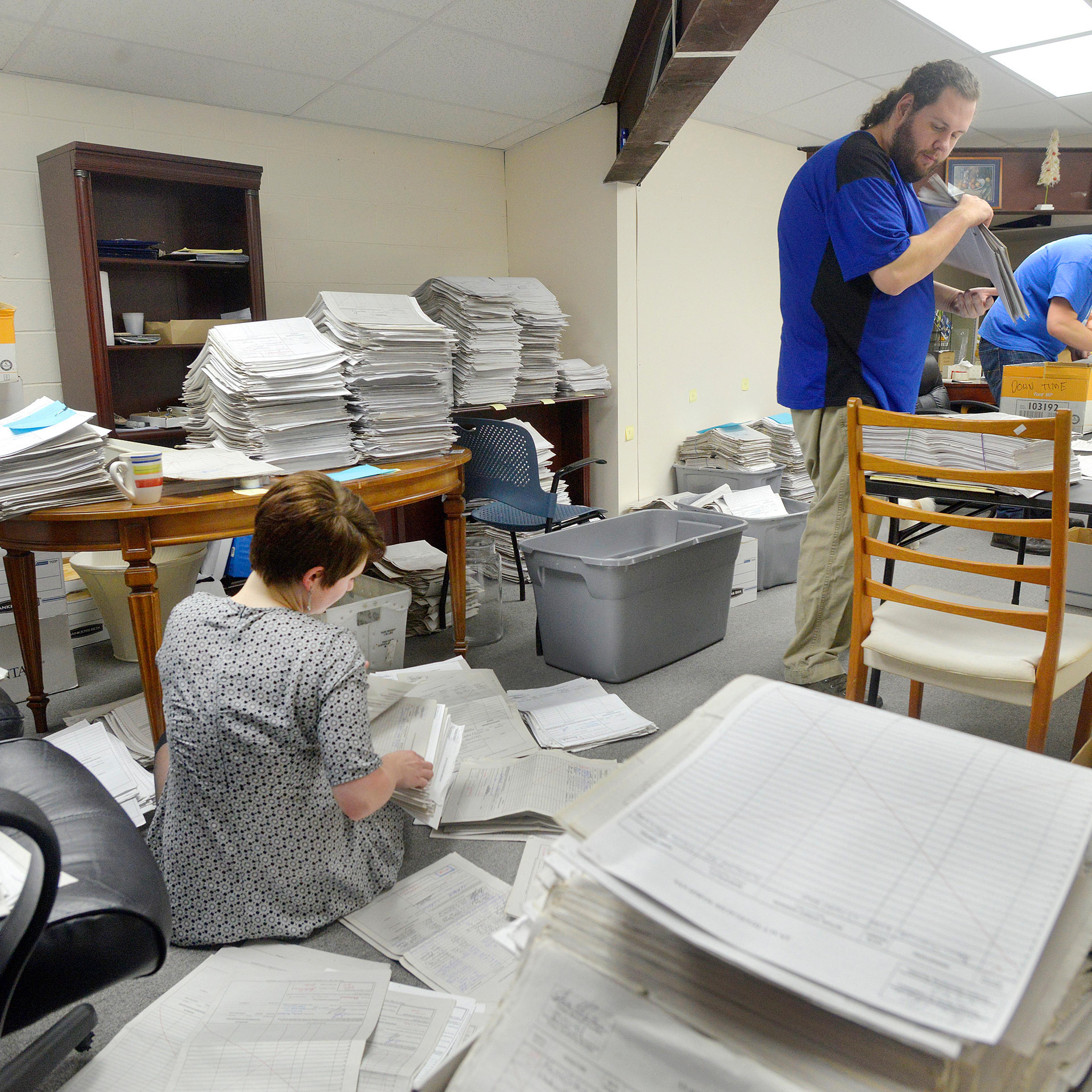 FALMOUTH, ME - JANUARY 26: Staff and volunteers for the marijuana legalization campaign are sorting petitions at their office in Falmouth. Volunteer Allison Cormier (left) along with office manager Shaun Bowen (center) and field director Jordan DeCoster