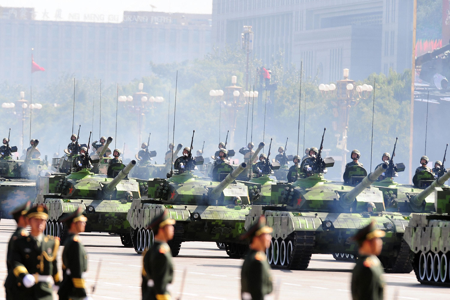 Chinese People's Liberation Army (PLA) tanks rumble past Tiananmen Square during the National Day parade in Beijing