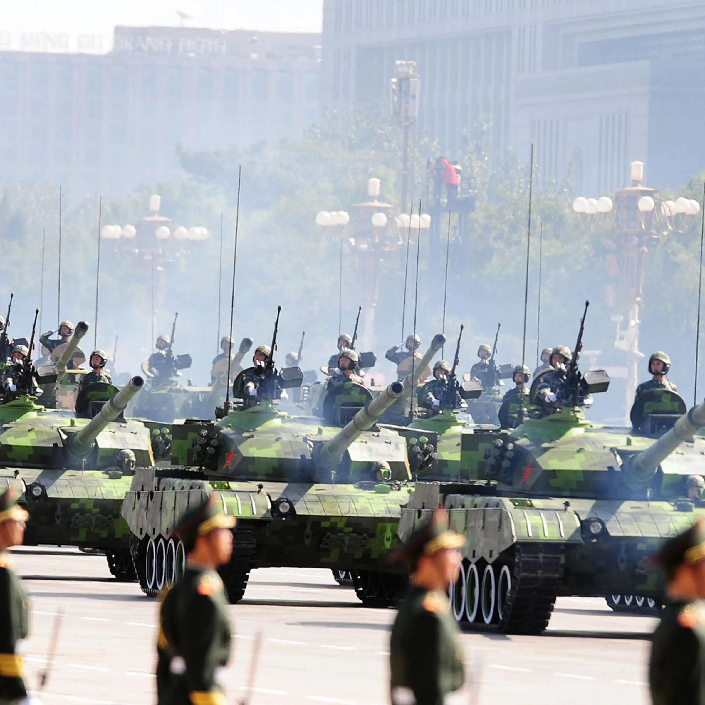 Chinese People's Liberation Army (PLA) tanks rumble past Tiananmen Square during the National Day parade in Beijing