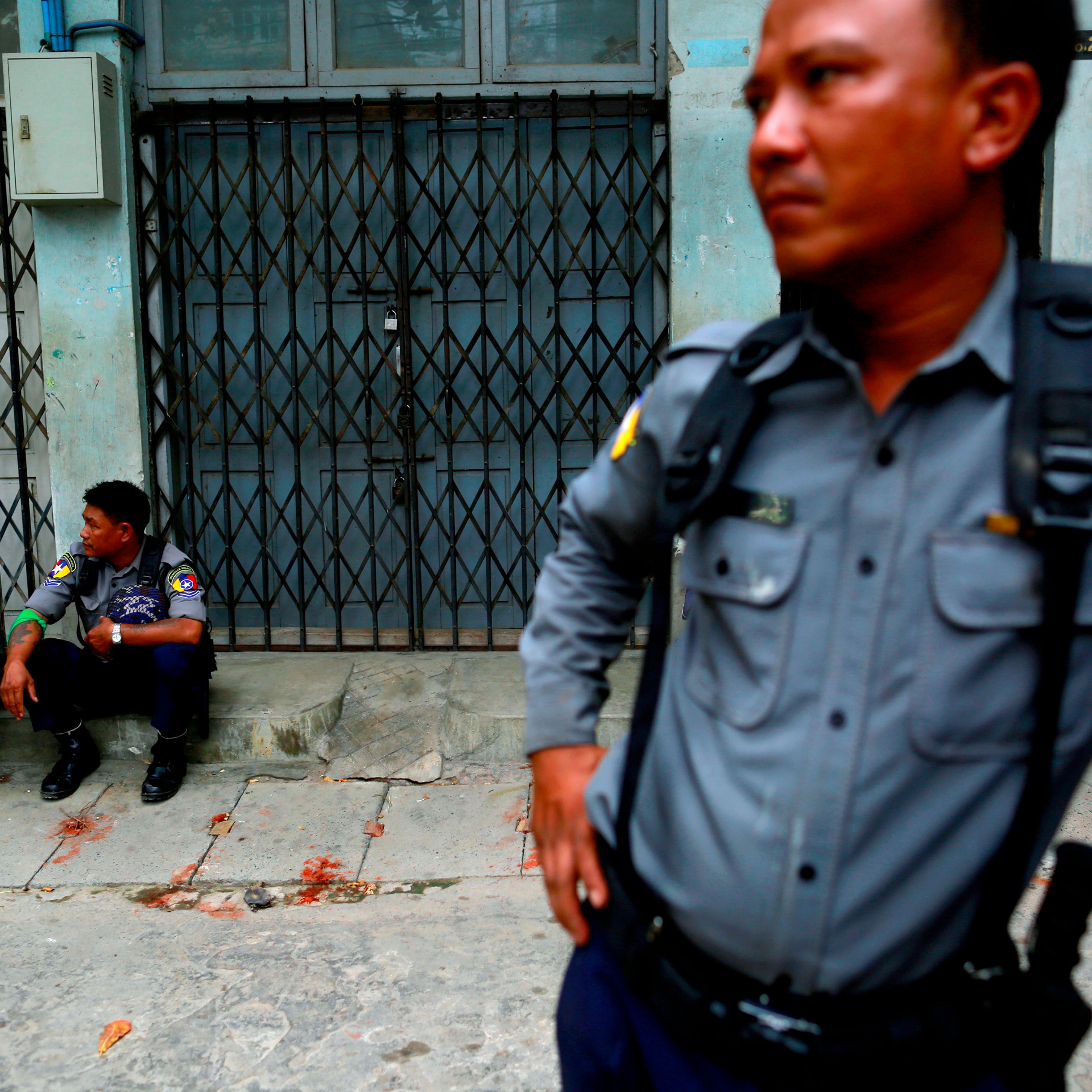 Police officers guard a Muslim residential area in Mandalay