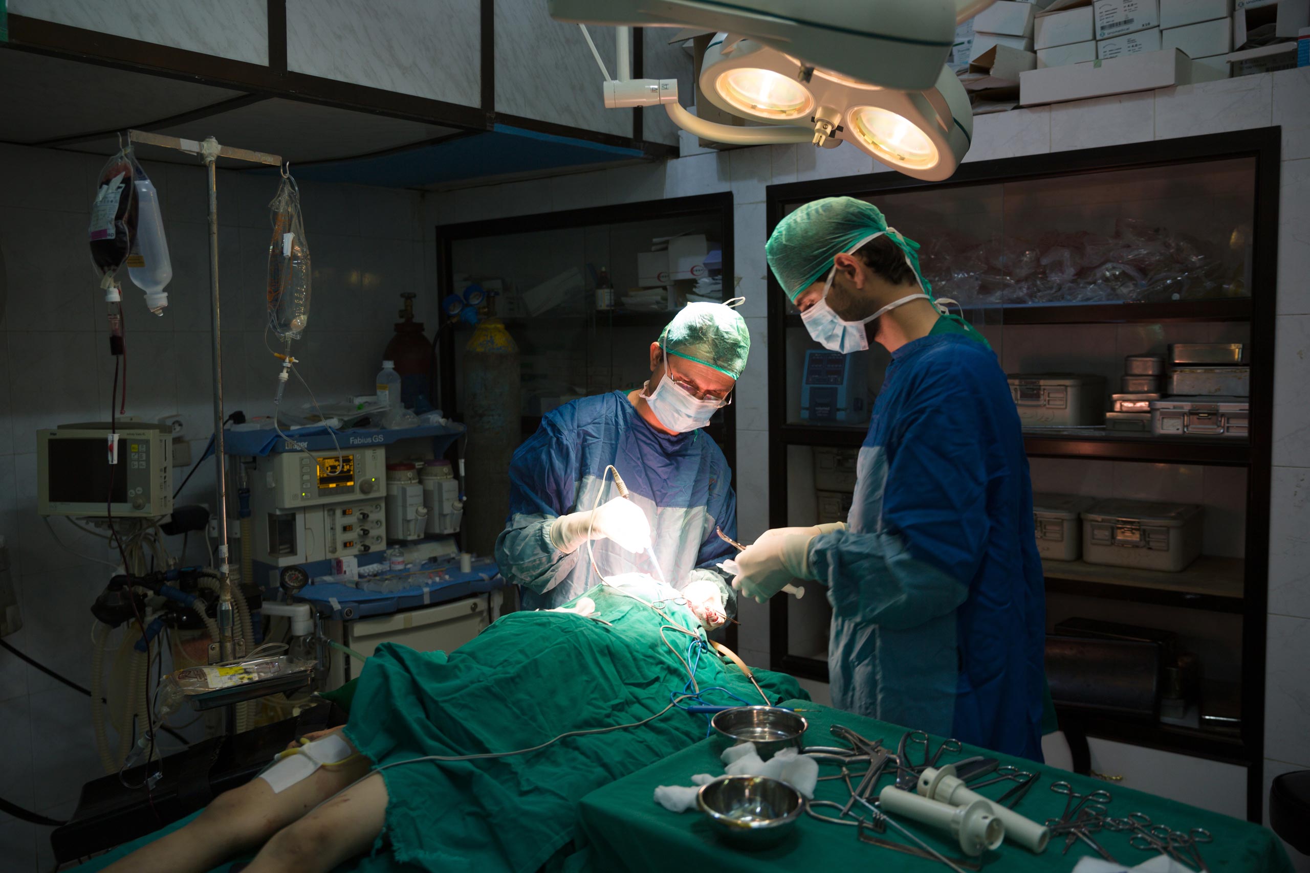 Neurosurgeons operate on a 10-year-old-boy after an ISIS mortar shell hit his street in the besieged city of Deir-ez Zor, May 25, 2015.