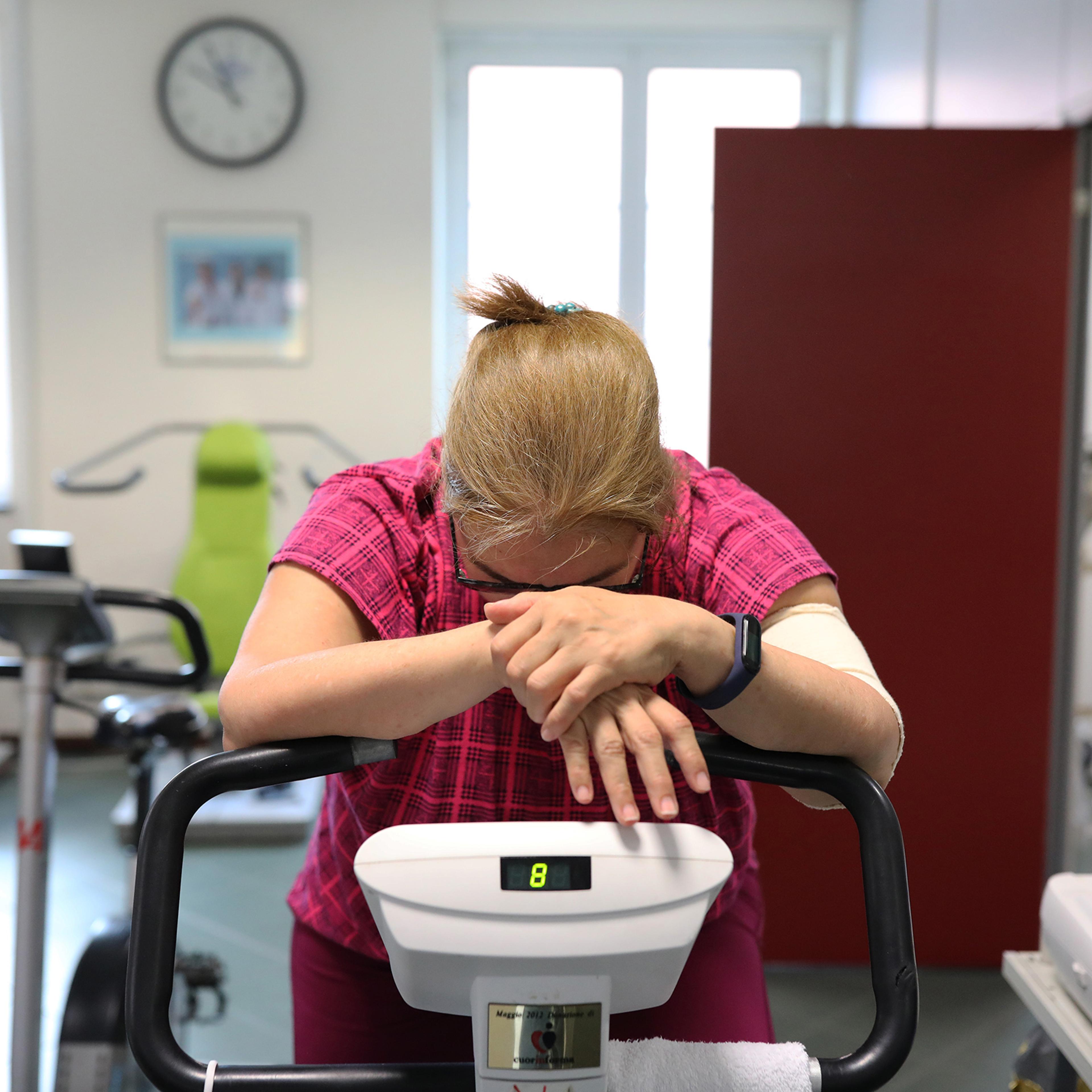 A former COVID-19 patient rides on an exercise bike to strengthen muscle tone at the Department of Rehabilitative Cardiology of ASL 3 Genova on July 24 in Genoa, Italy. She contracted Covid-19 and remained in hospital for 15 days, currently suffering fro