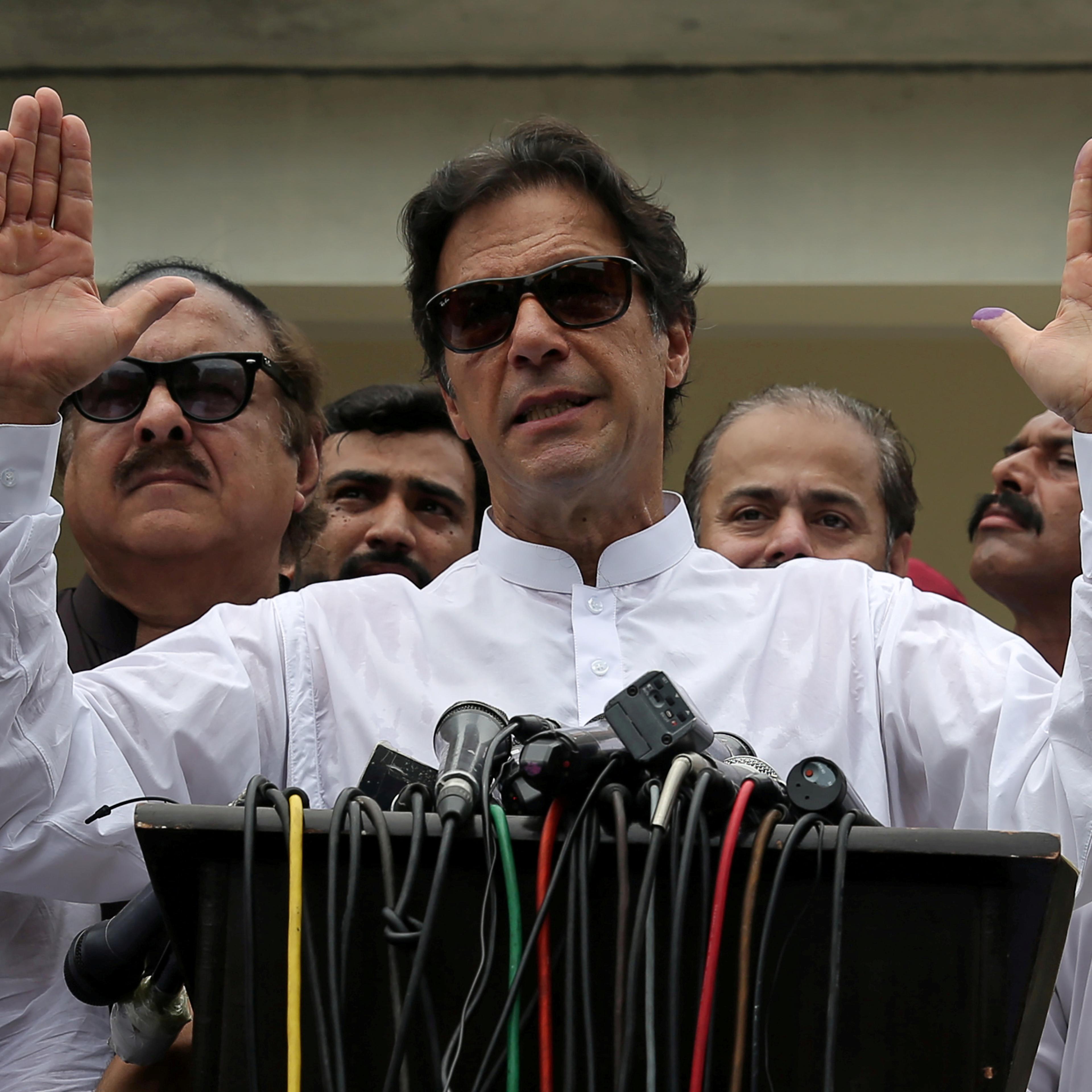 Imran Khan speaks to members of media after casting his vote at a polling station during the general election in Islamabad