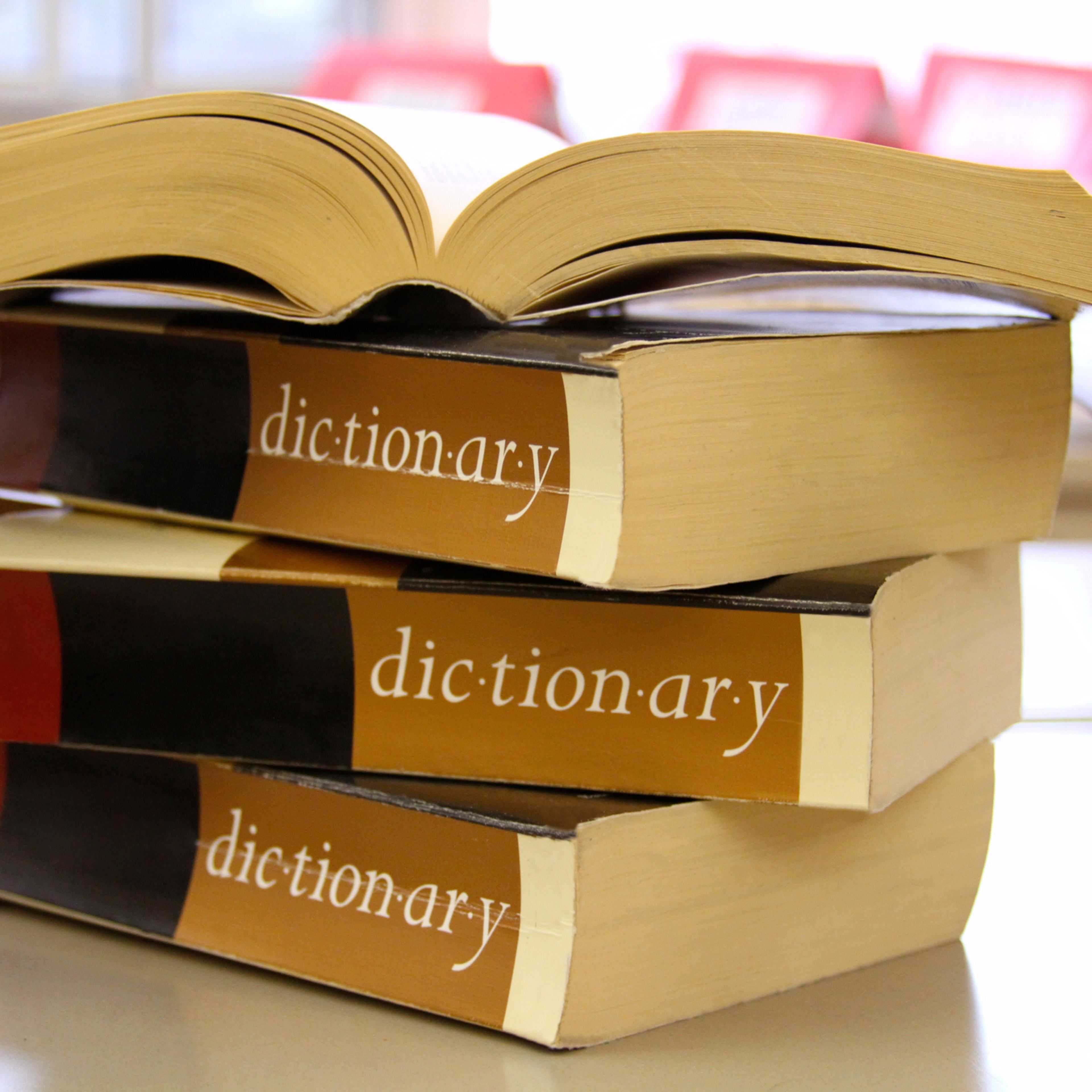 Stack of dictionaries on a desk