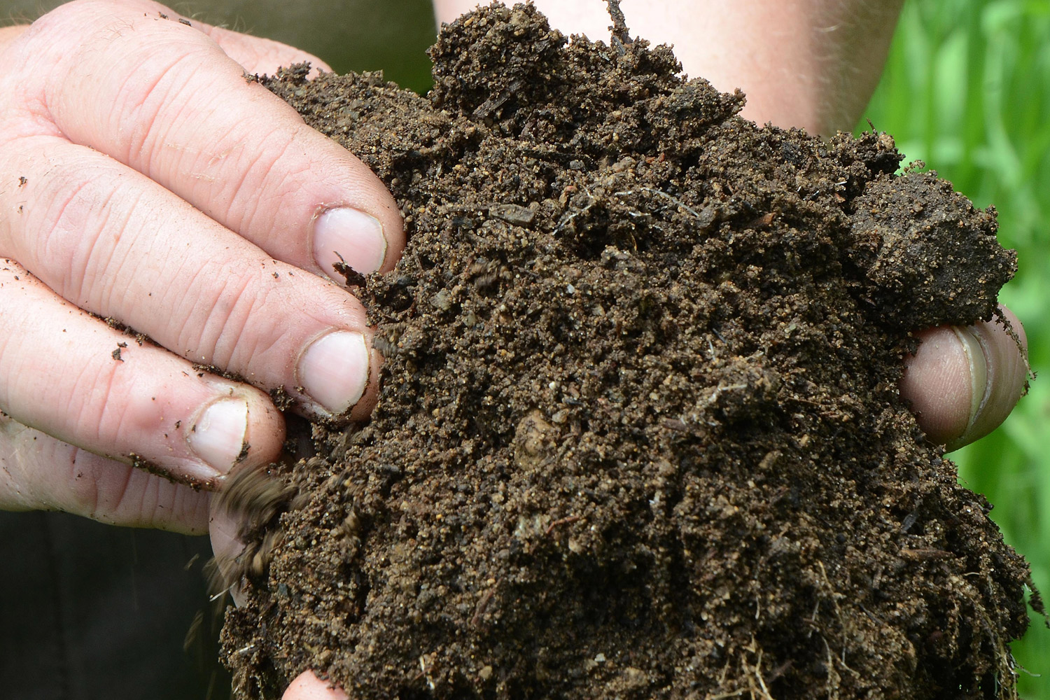 Frank Cummins, horticulturist at Binder Park Zoo, holds some of the manure/compost the zoo will have for sale, in Battle Creek, Mich. on May 27, 2014. 