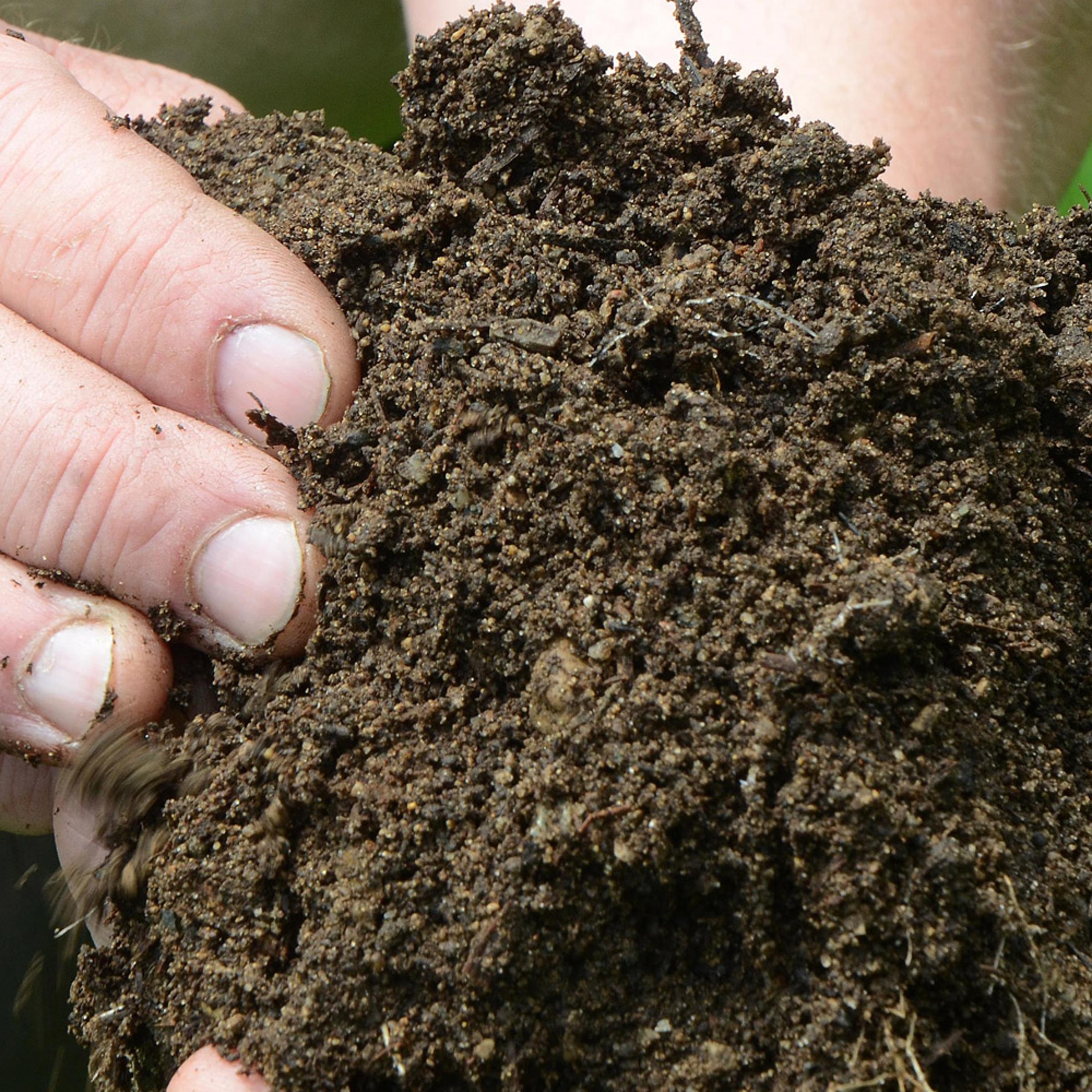 Frank Cummins, horticulturist at Binder Park Zoo, holds some of the manure/compost the zoo will have for sale, in Battle Creek, Mich. on May 27, 2014.