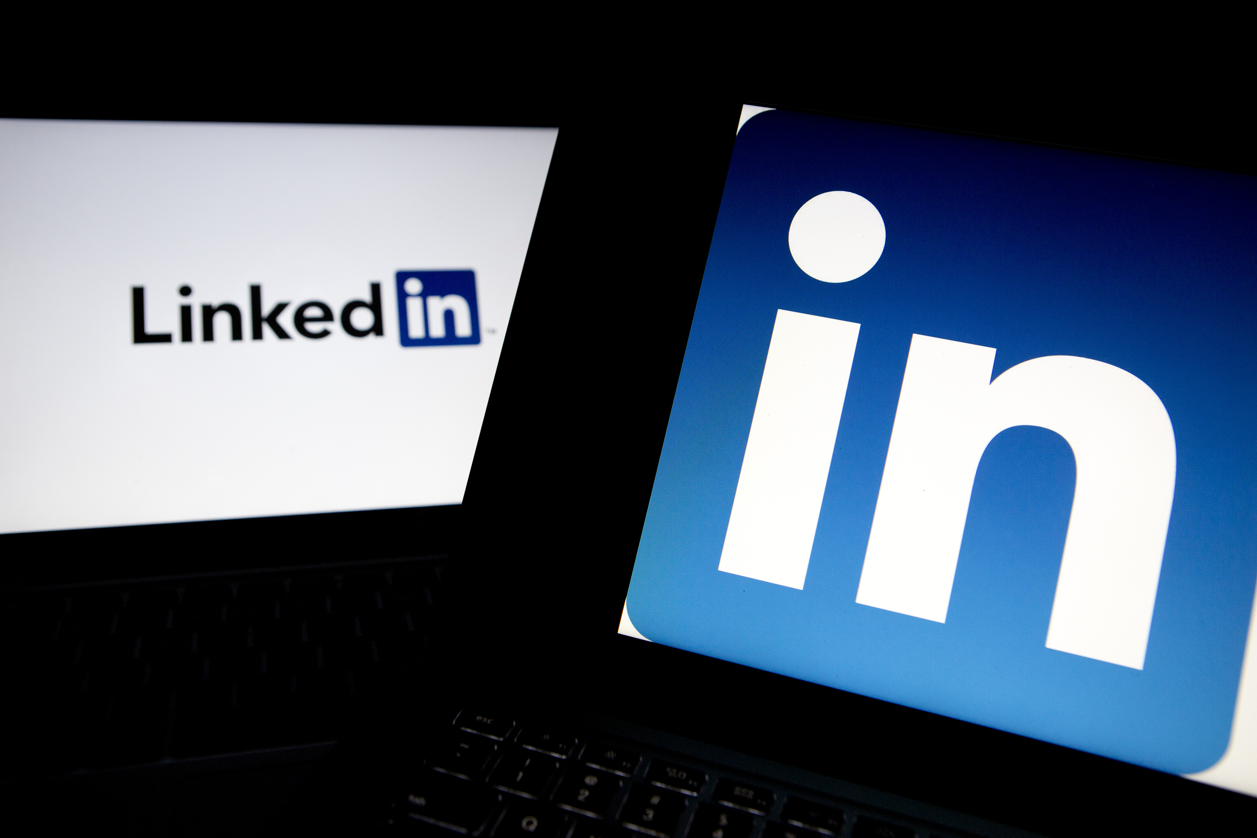 LinkedIn Corp. logos are displayed on laptop computers arranged for a photograph.