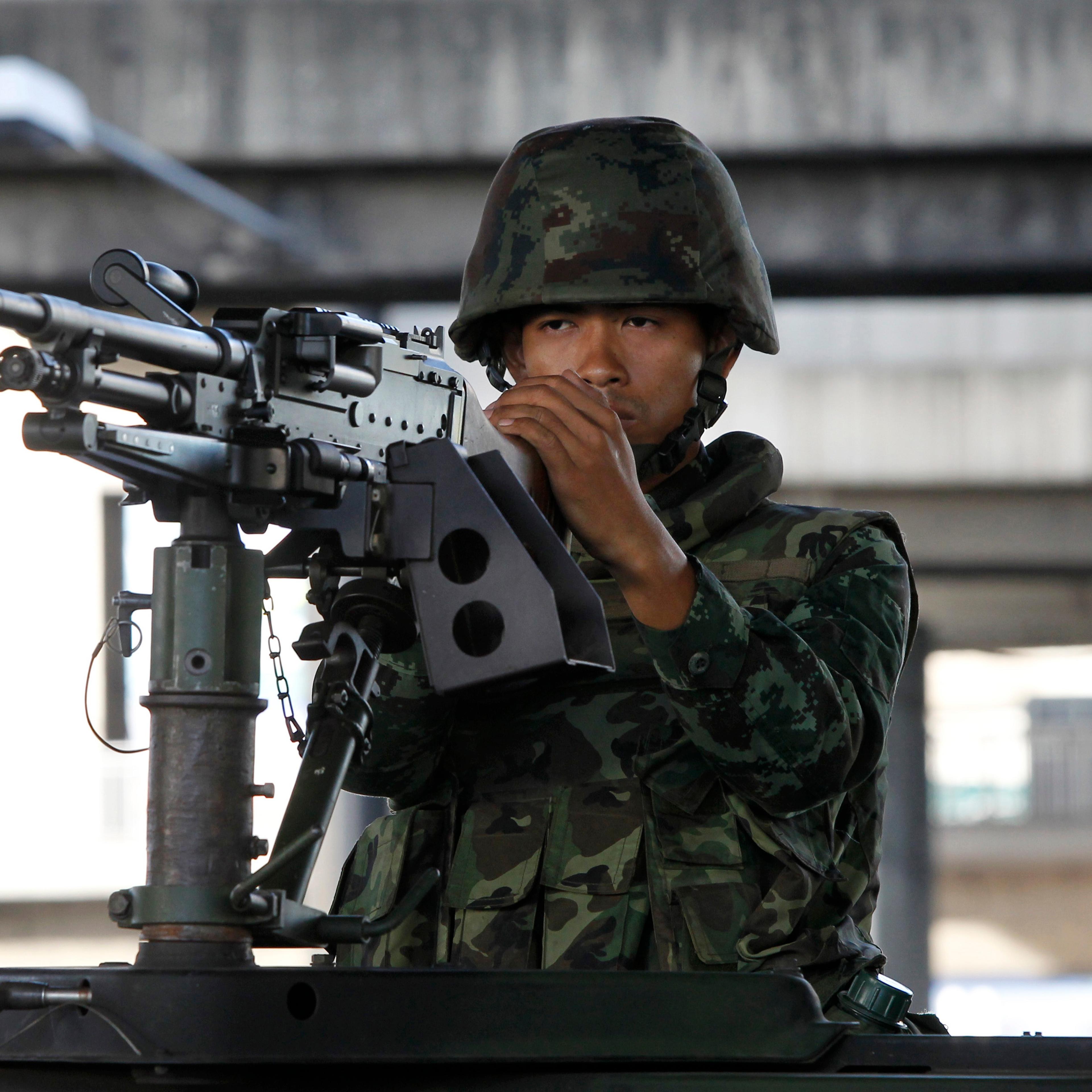 A Thai soldier mans a machine gun in central Bangkok