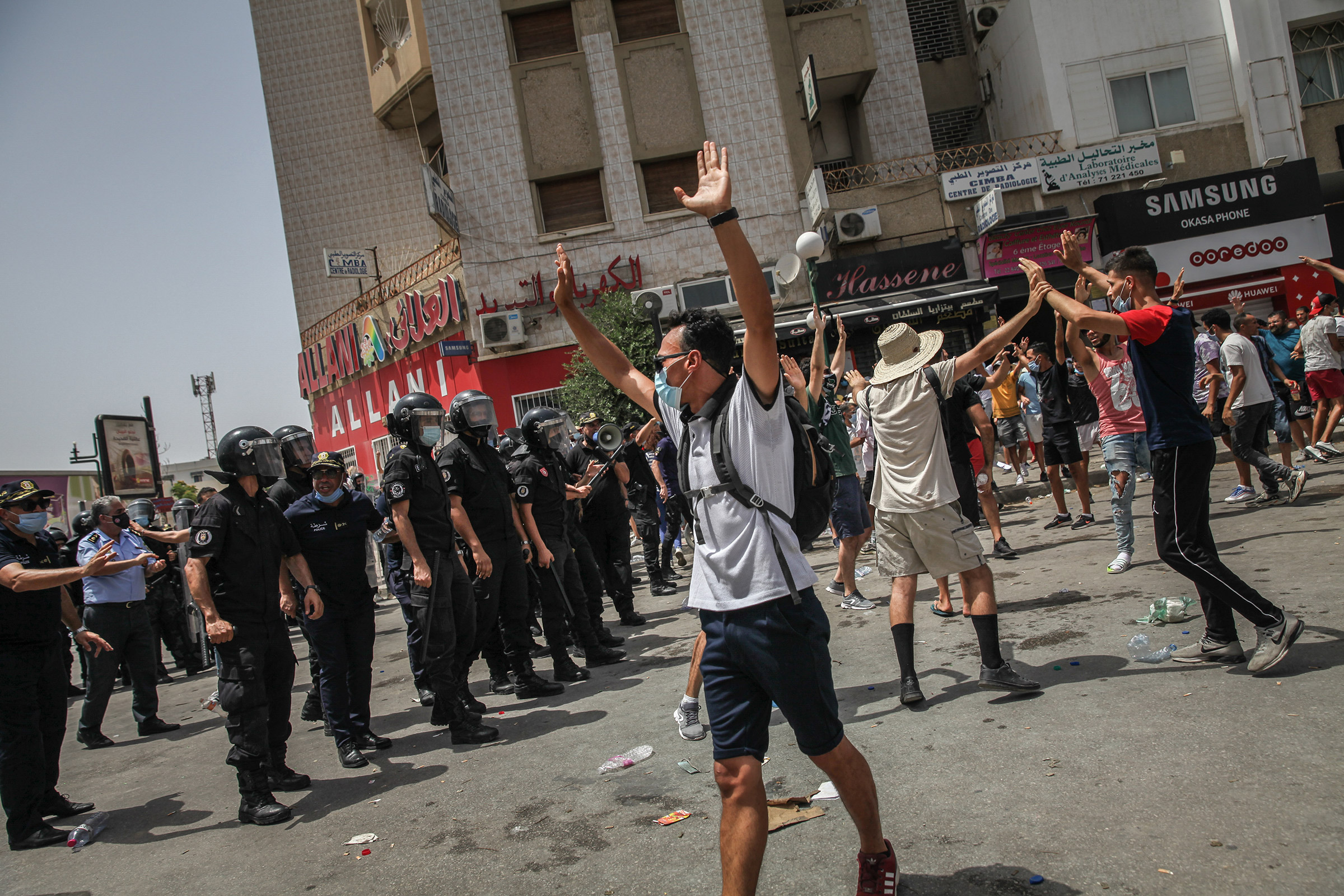 Protesters and riot police clash during a demonstration held near Parliament in Tunis, Tunisia, on July 25, 2021.