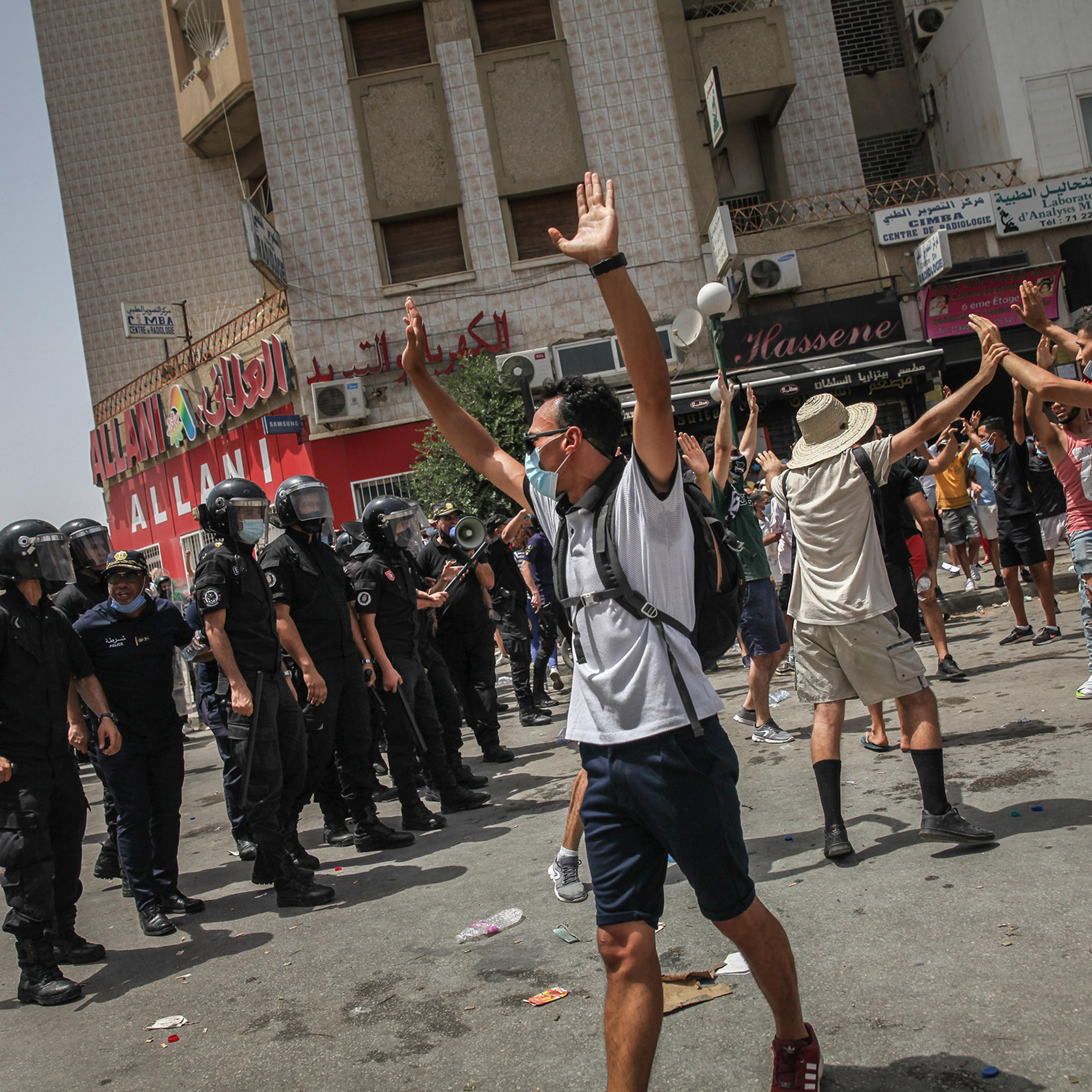Protesters and riot police clash during a demonstration held near Parliament in Tunis, Tunisia, on July 25, 2021.