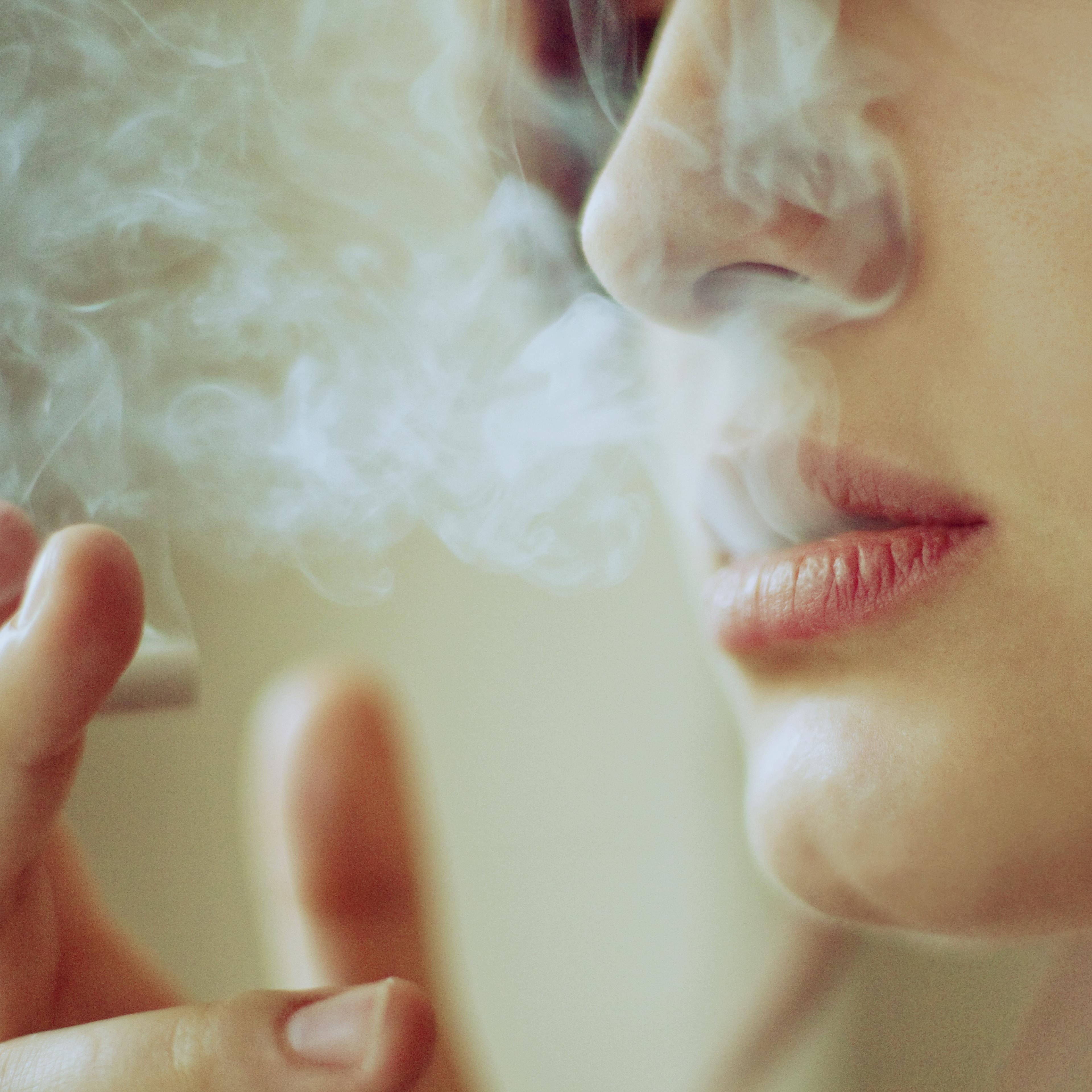 Young woman smoking in morning