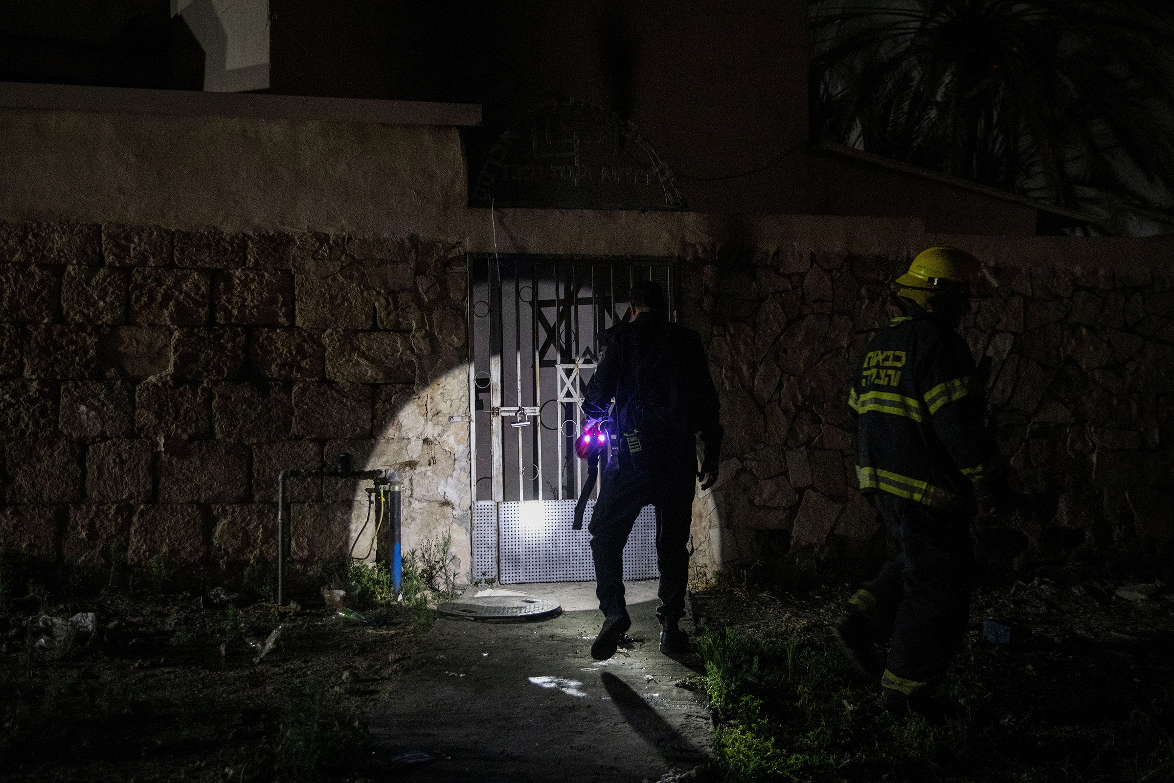 Firefighters inspect a synagogue after it was set on fire in Lod on May 14, 2021.