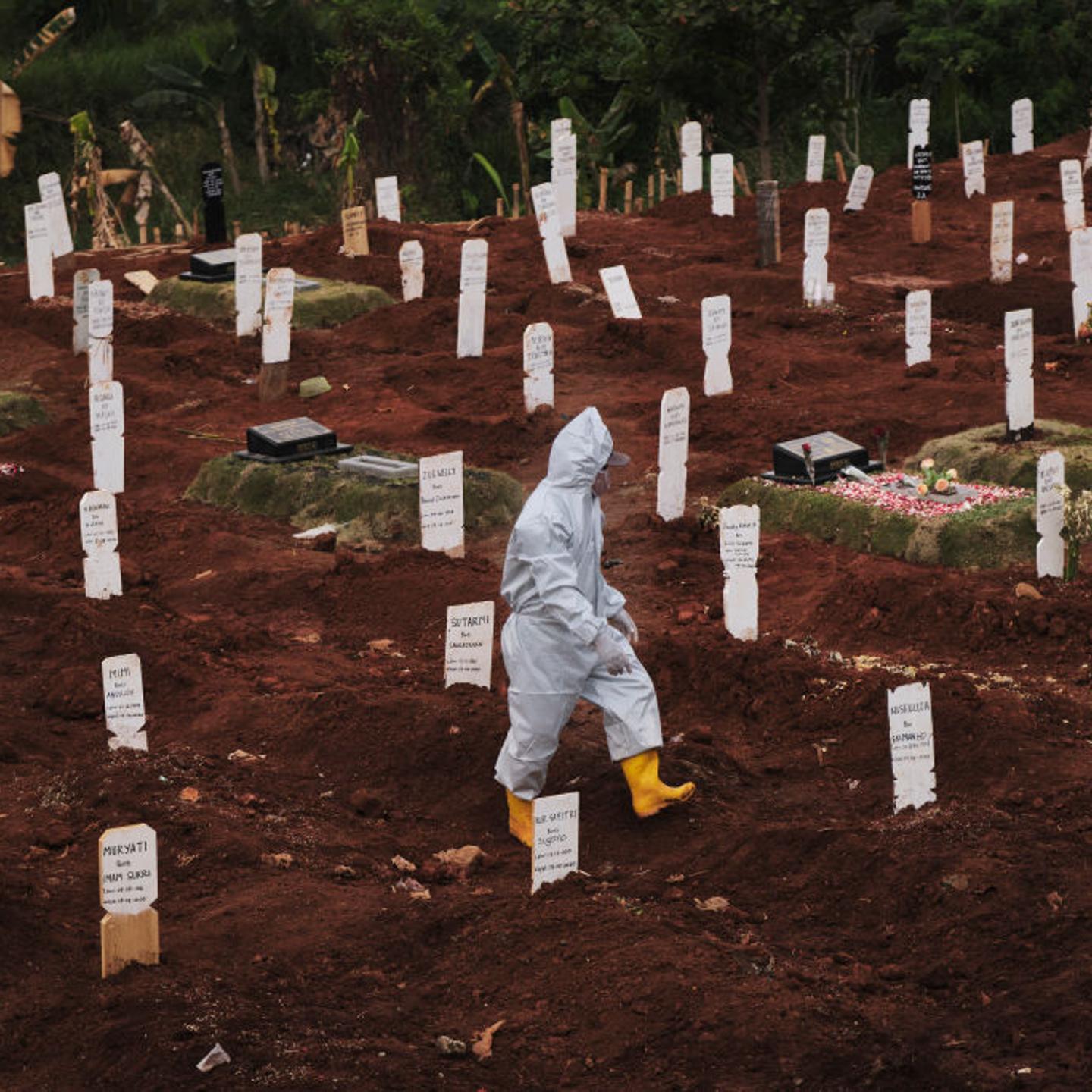 A municipal cemetery worker walks through a special cemetery for suspected Covid-19 victims on September 11, 2020 in Jakarta, Indonesia.