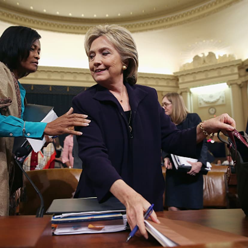 Former State Department Chief of Staff Cheryl Mills (L) and Democratic presidential candidate and former Secretary of State Hillary Clinton take a break in a hearing of the House Select Committee on Benghazi October 22, 2015 on Capitol Hill in Washington