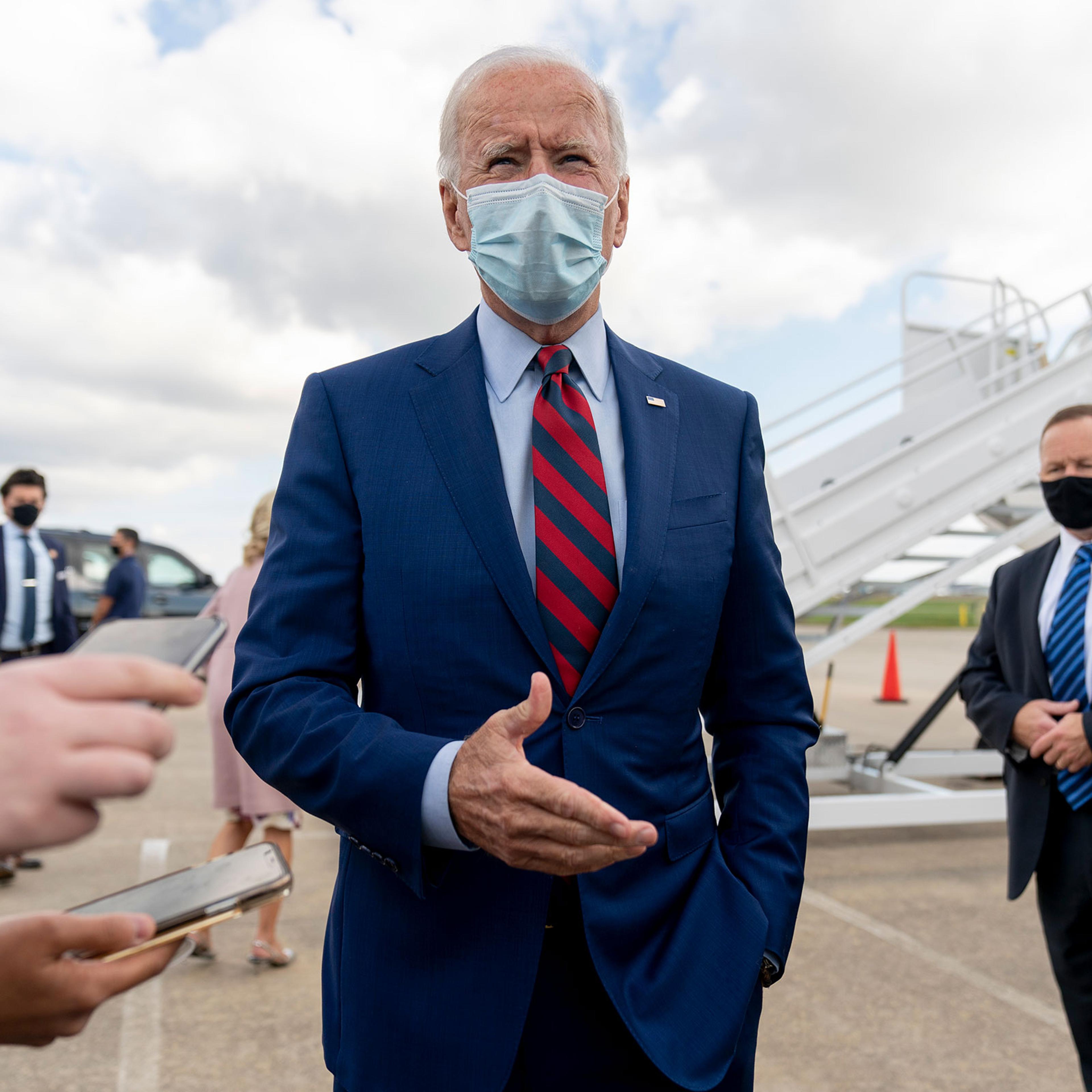 Democratic presidential candidate former Vice President Joe Biden speaks to member of the media before boarding his campaign plane at New Castle Airport in New Castle,