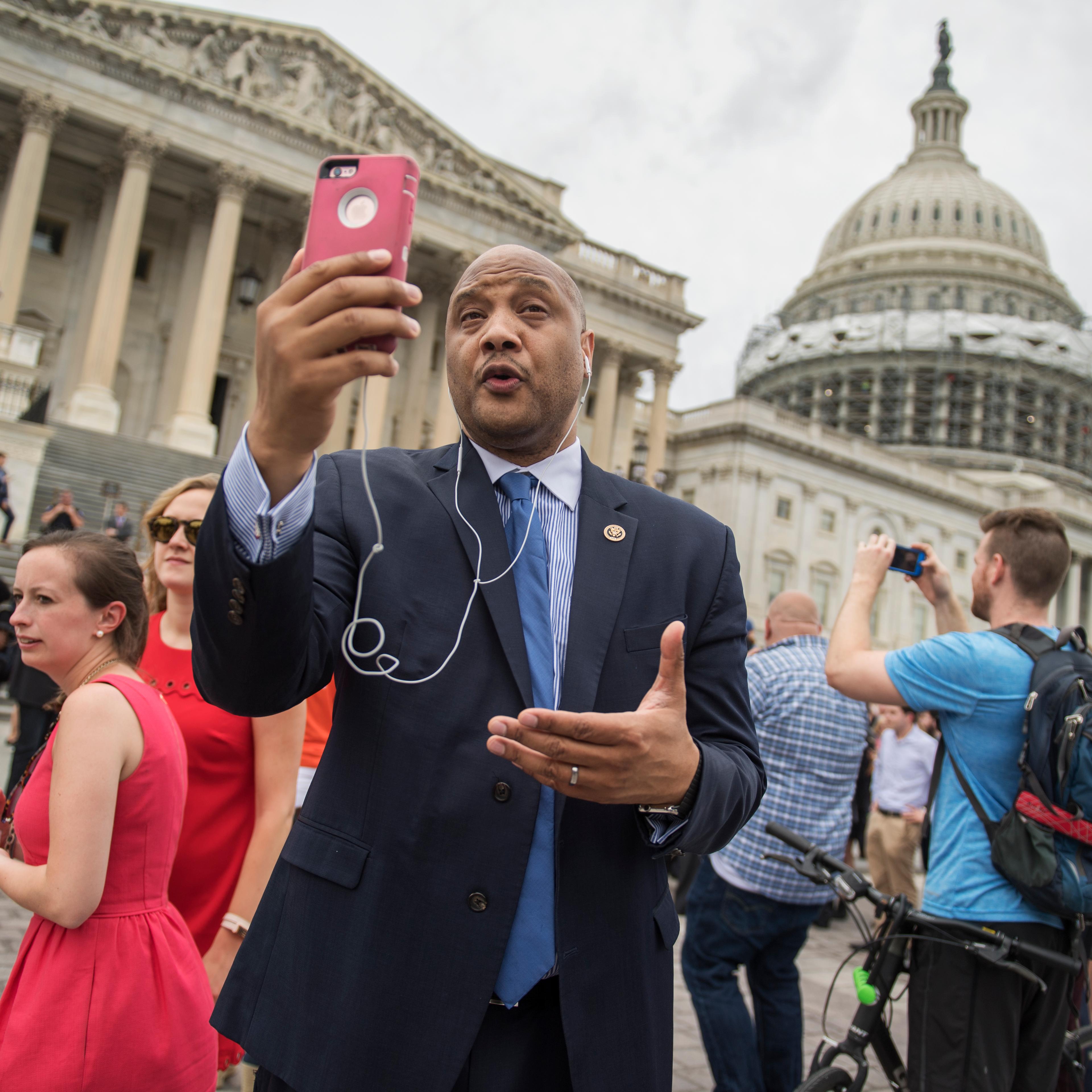 Rep. Andre Carson, D-Ind., concurs an interview via FaceTime on the East Front of the Capitol after the House Democrats' sit-in ended on the floor, June 23, 2016.