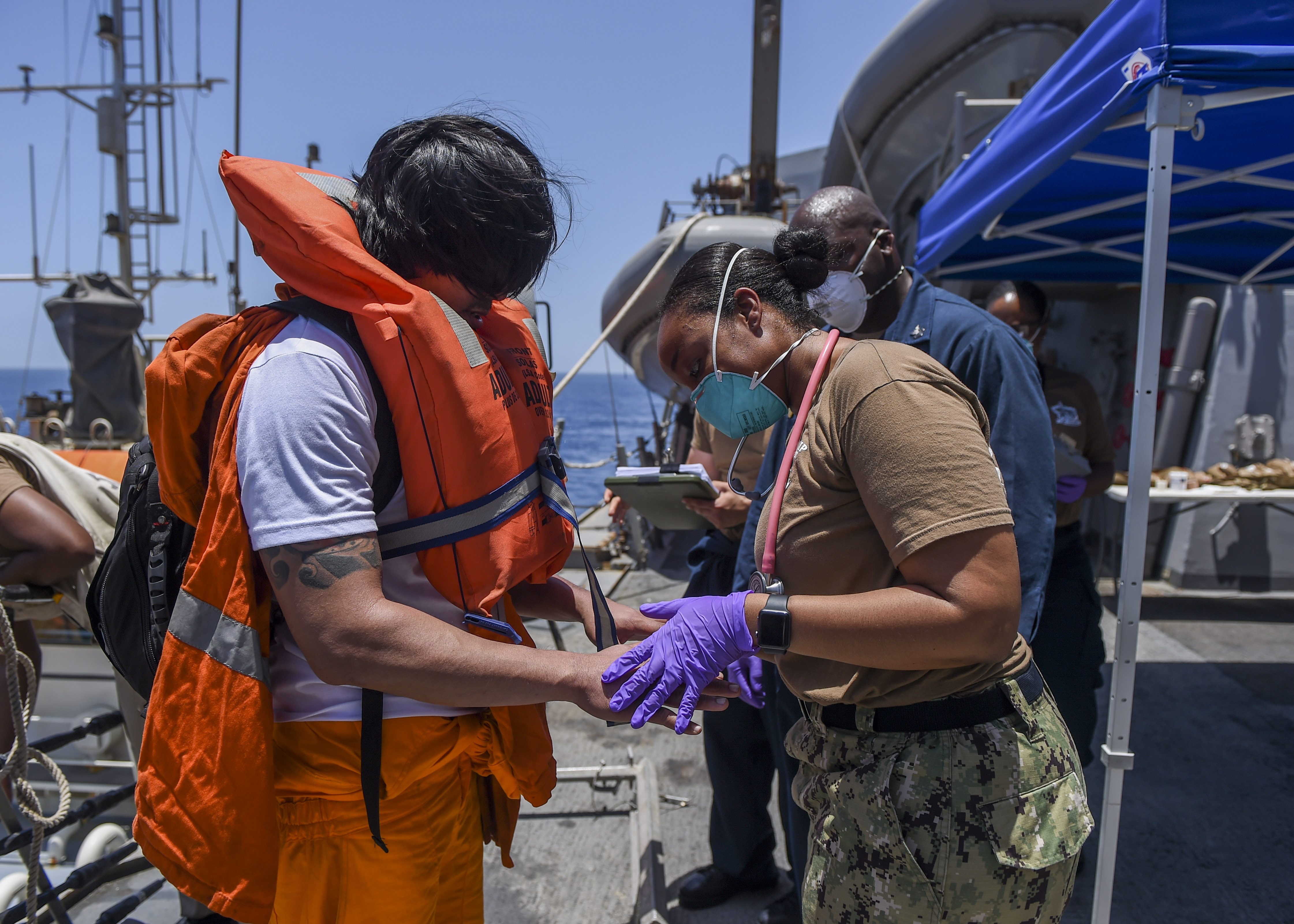 Sailors aboard the Arleigh Burke-class guided-missile destroyer USS Bainbridge render aid to the crew of the M/V Kokuka Courageous on June 13, 2019. 