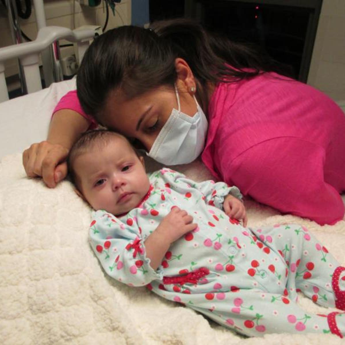 Alysia Padilla-Vacarro and daughter Evangelina on the day of her gene therapy treatment. Evangelina, now two years old, has had her immune system restored and lives a healthy and normal life.